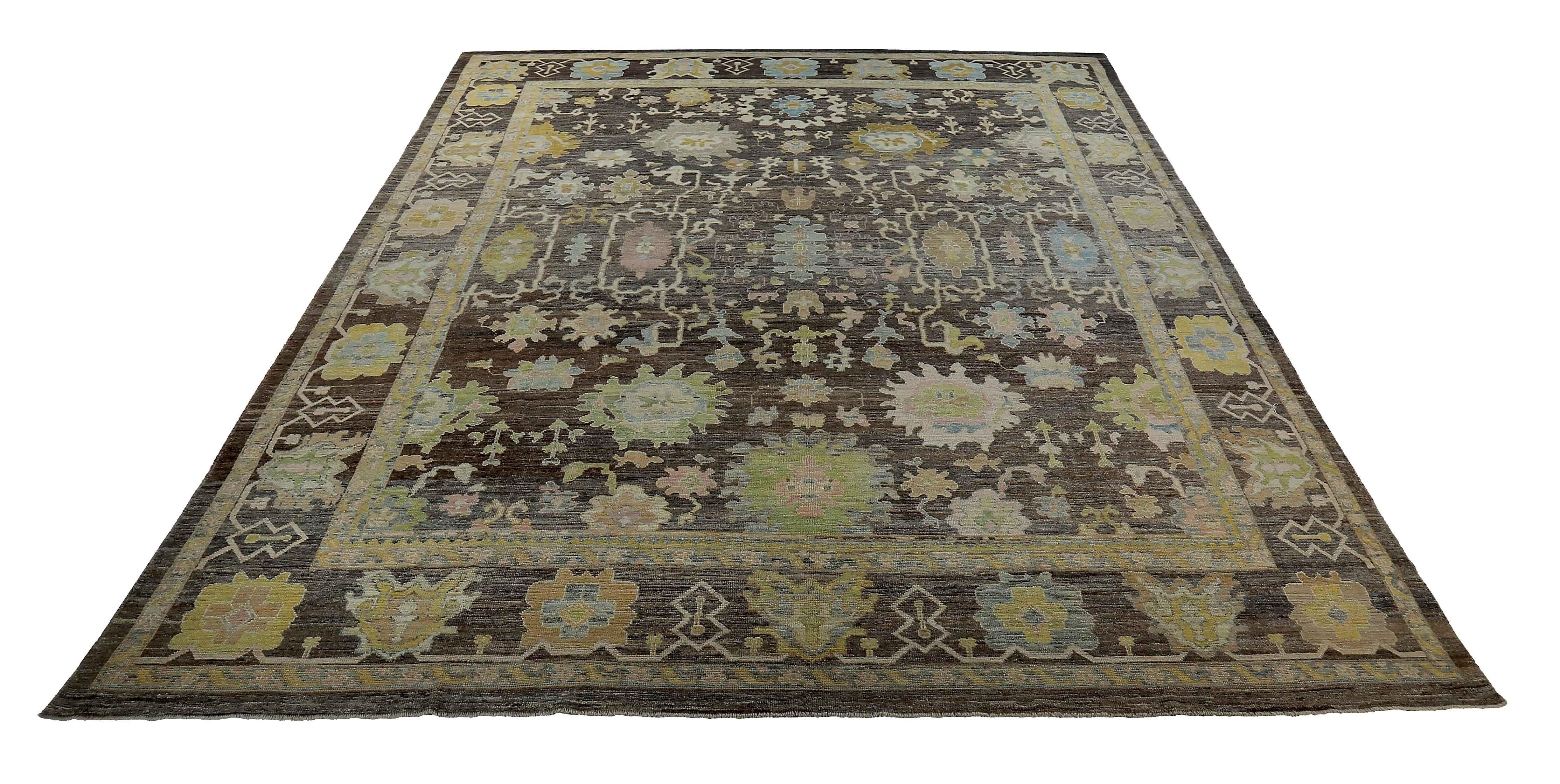 New Turkish rug made of handwoven sheep’s wool of the finest quality. It’s colored with organic vegetable dyes that are certified safe for humans and pets alike. It features colorful floral details on a rich brown and black field. Flower patterns