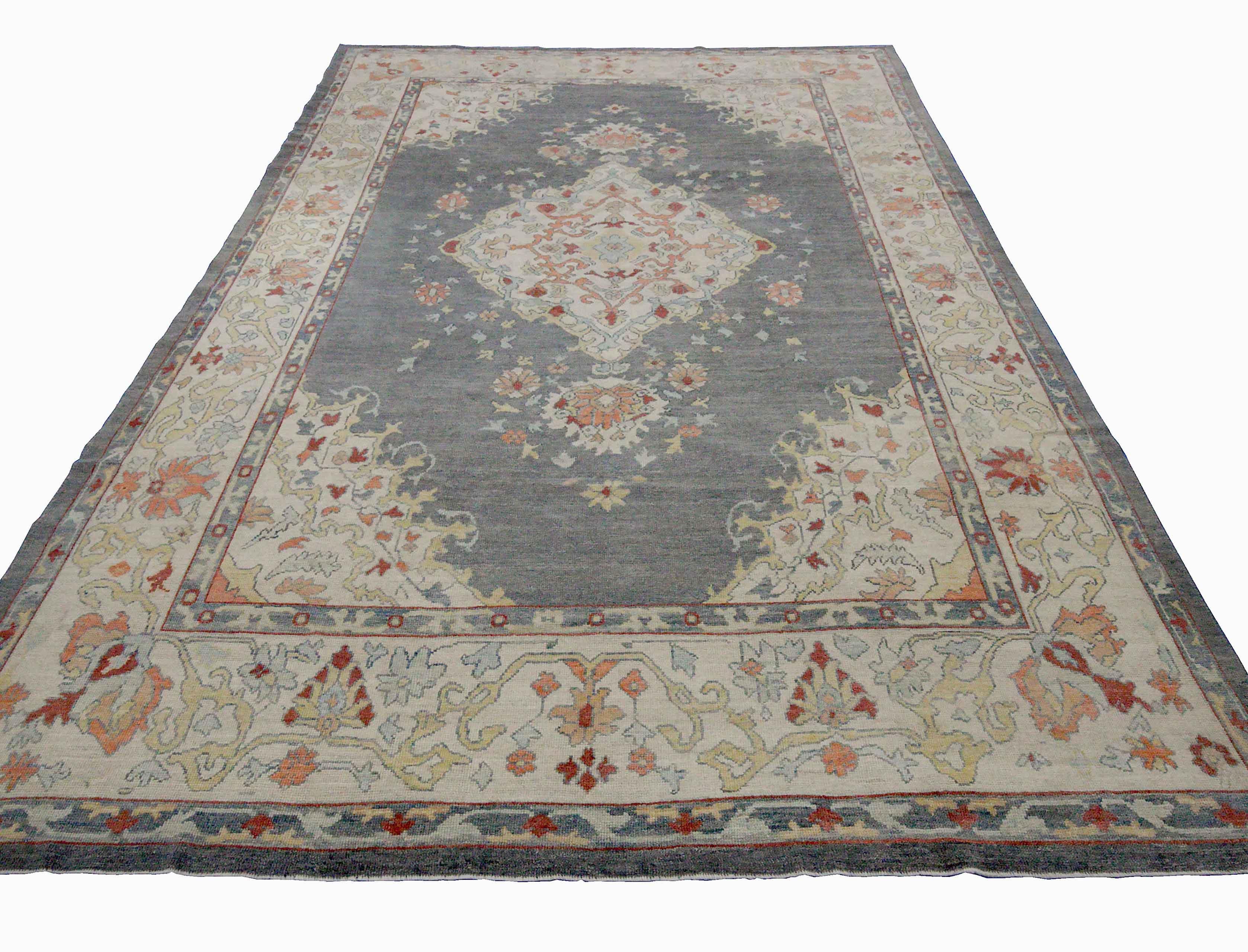 New Turkish runner rug made of handwoven sheep’s wool of the finest quality. It’s colored with organic vegetable dyes that are certified safe for humans and pets alike. It features floral details in pink and blue over a regal gray field. Flower