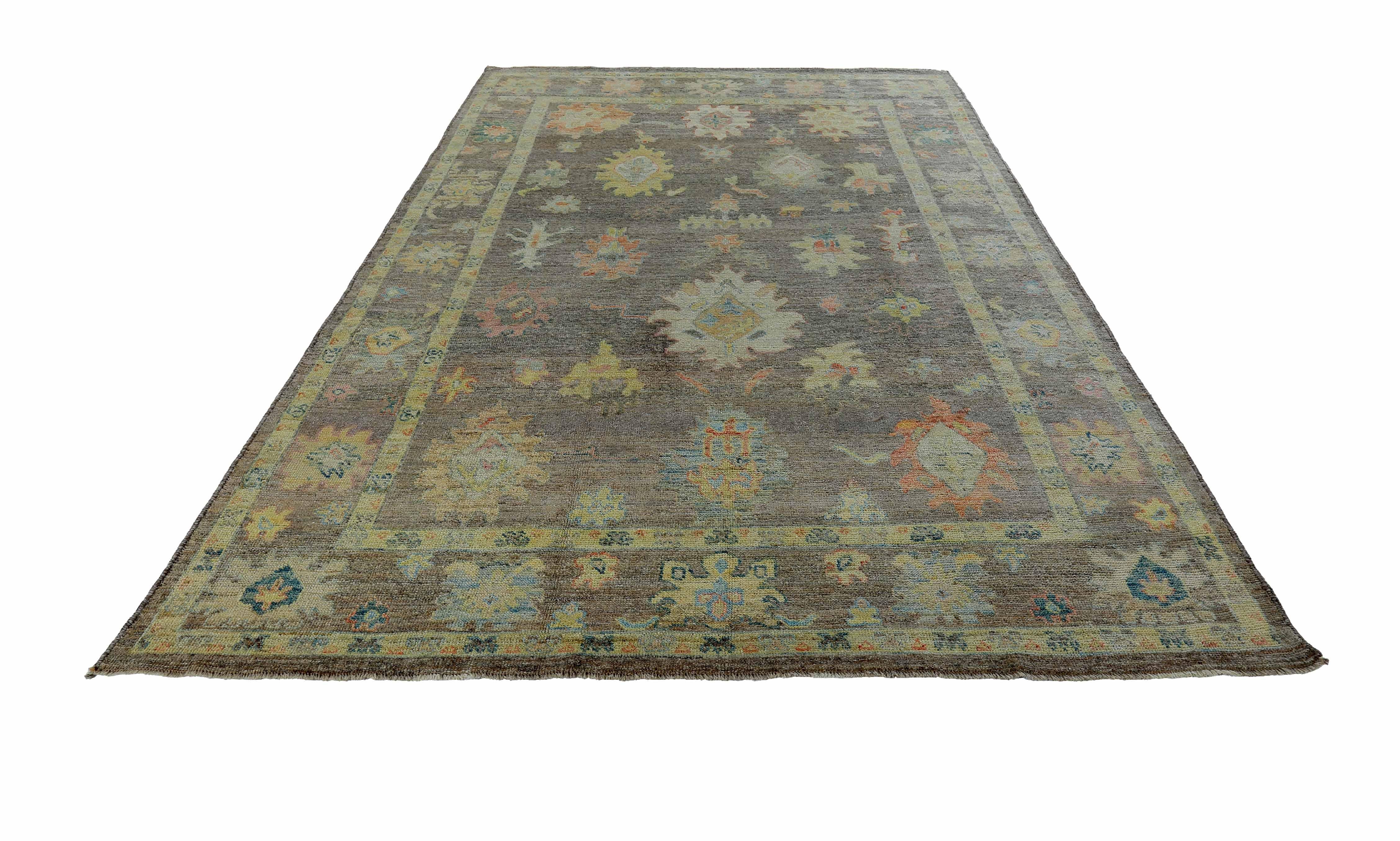 New Turkish rug made of handwoven sheep’s wool of the finest quality. It’s colored with organic vegetable dyes that are certified safe for humans and pets alike. It features bright colored flower heads adorning a rich brown field. Flower patterns