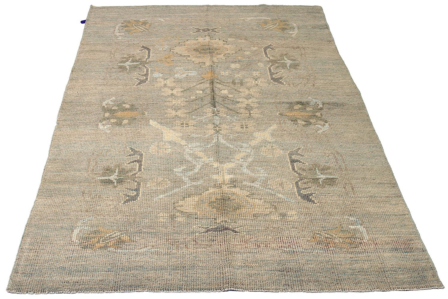 New Turkish rug made of handwoven sheep’s wool of the finest quality. It’s colored with organic vegetable dyes that are certified safe for humans and pets alike. It features gray and beige botanical details associated with Oushak weaving from