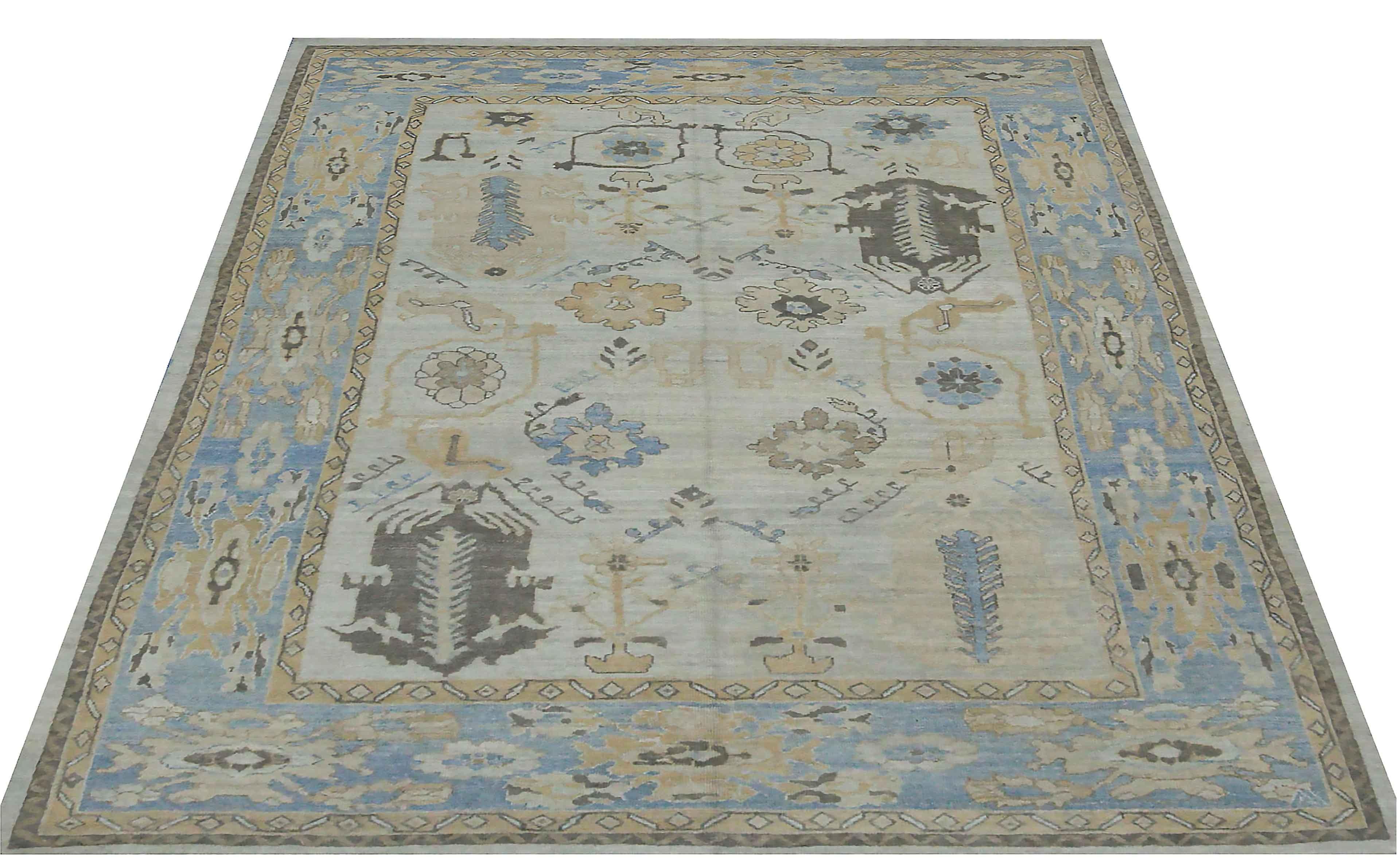 New Turkish rug made of handwoven sheep’s wool of the finest quality. It’s colored with organic vegetable dyes that are certified safe for humans and pets alike. It features gray and beige floral details on a cool blue field. Flower patterns are