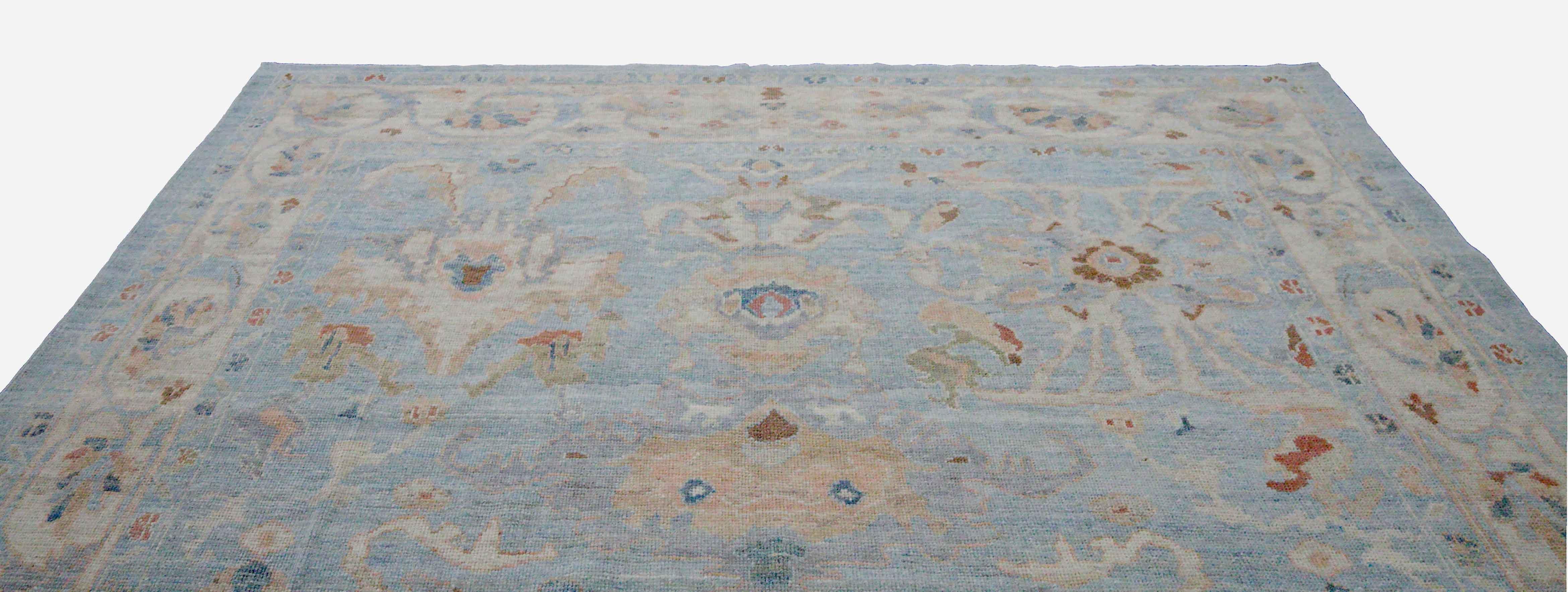 Hand-Woven New Turkish Oushak Rug with Green and Beige Floral Details on Blue Field For Sale