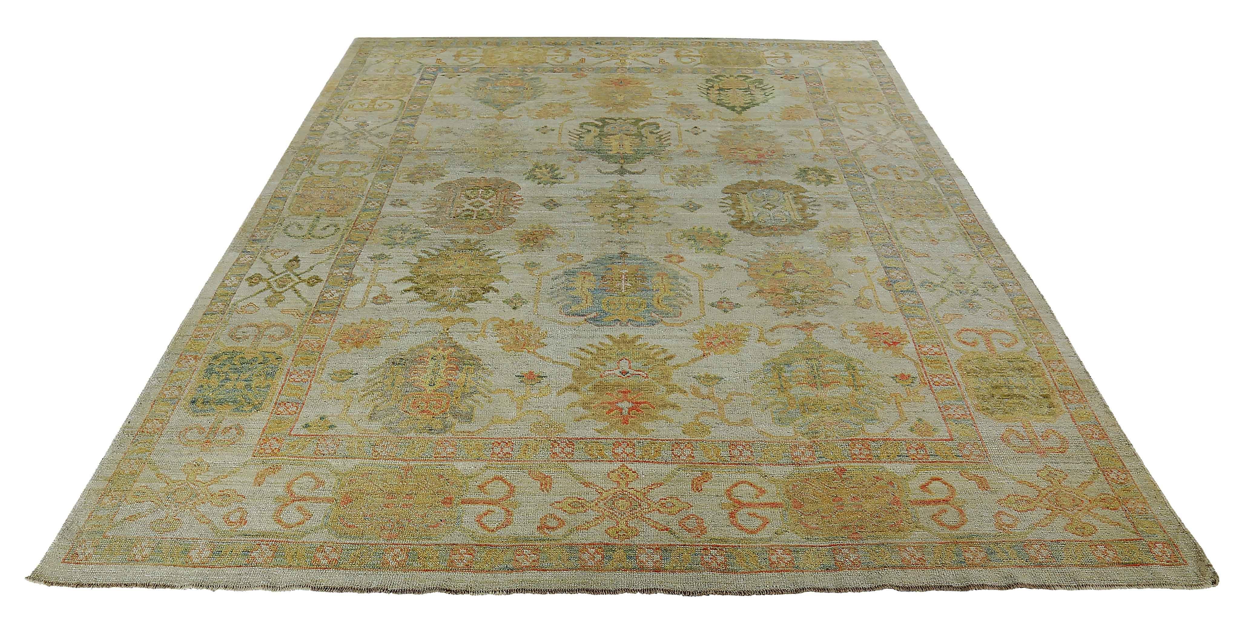 New Turkish rug made of handwoven sheep’s wool of the finest quality. It’s colored with organic vegetable dyes that are certified safe for humans and pets alike. It features green and gray floral heads on an ivory field. Flower patterns are commonly