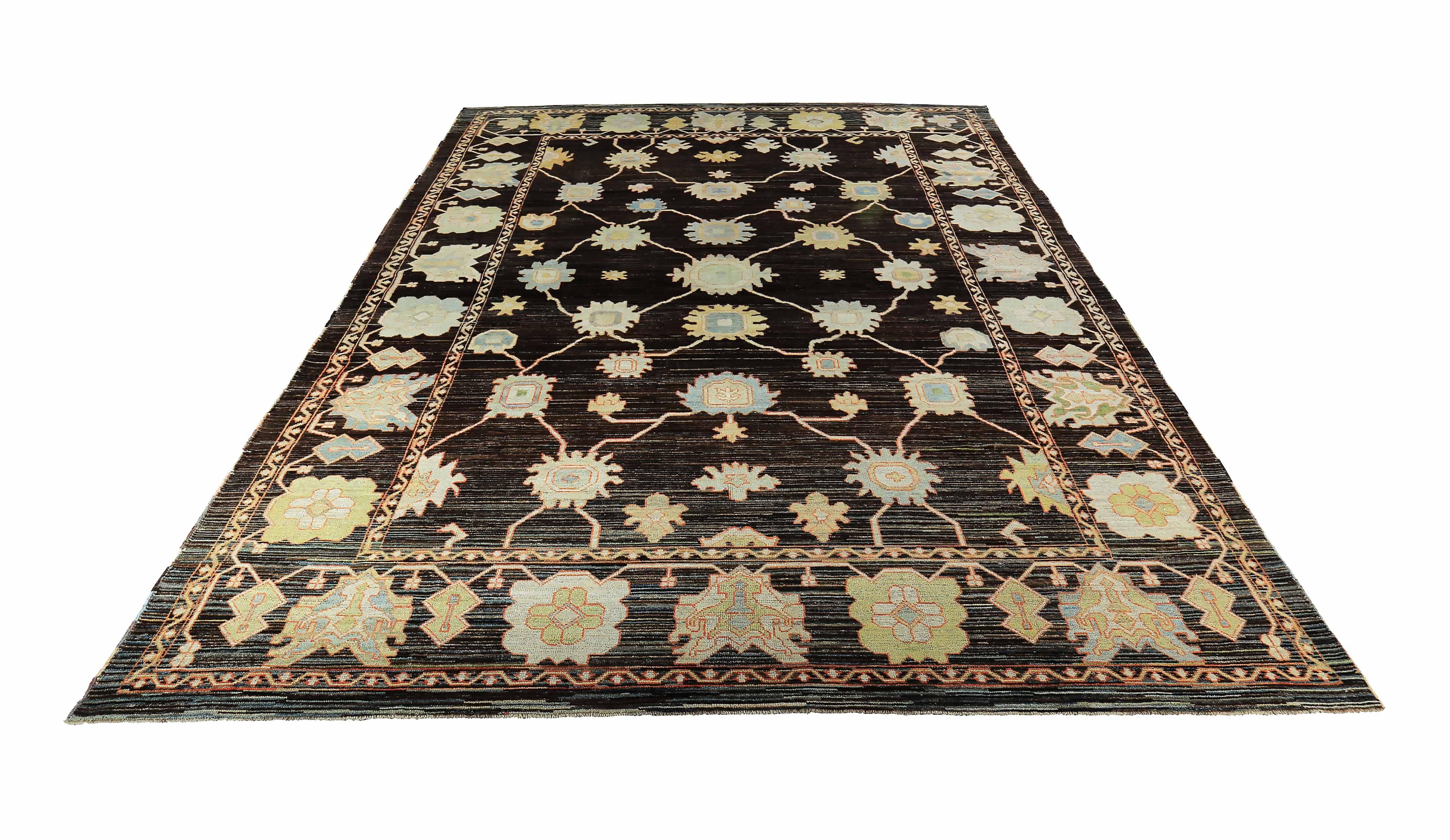 New Turkish rug made of handwoven sheep’s wool of the finest quality. It’s colored with organic vegetable dyes that are certified safe for humans and pets alike. It features green and light blue floral details on a rich brown field with hints of