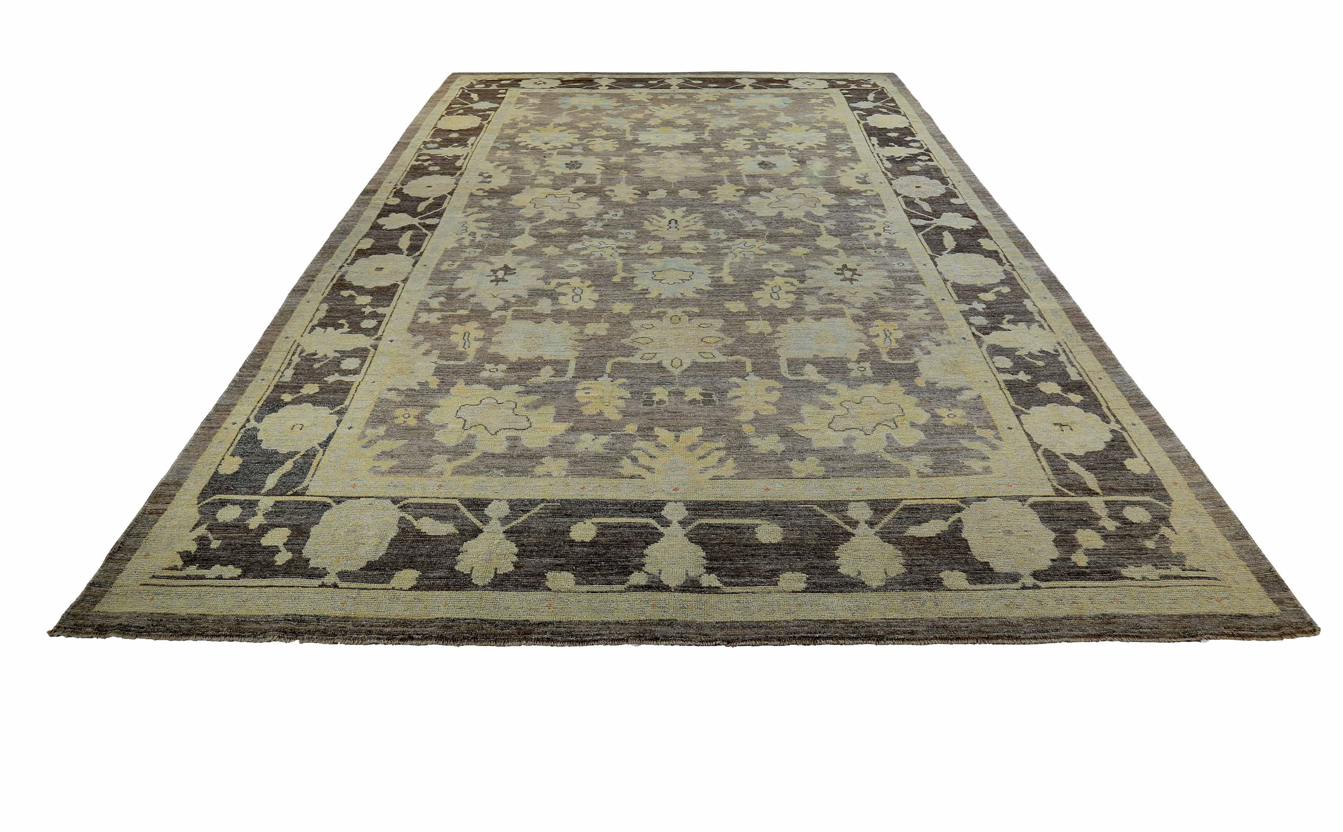 New Turkish rug made of handwoven sheep’s wool of the finest quality. It’s colored with organic vegetable dyes that are certified safe for humans and pets alike. It features ivory and blue floral details on an elegant brown field. Flower patterns
