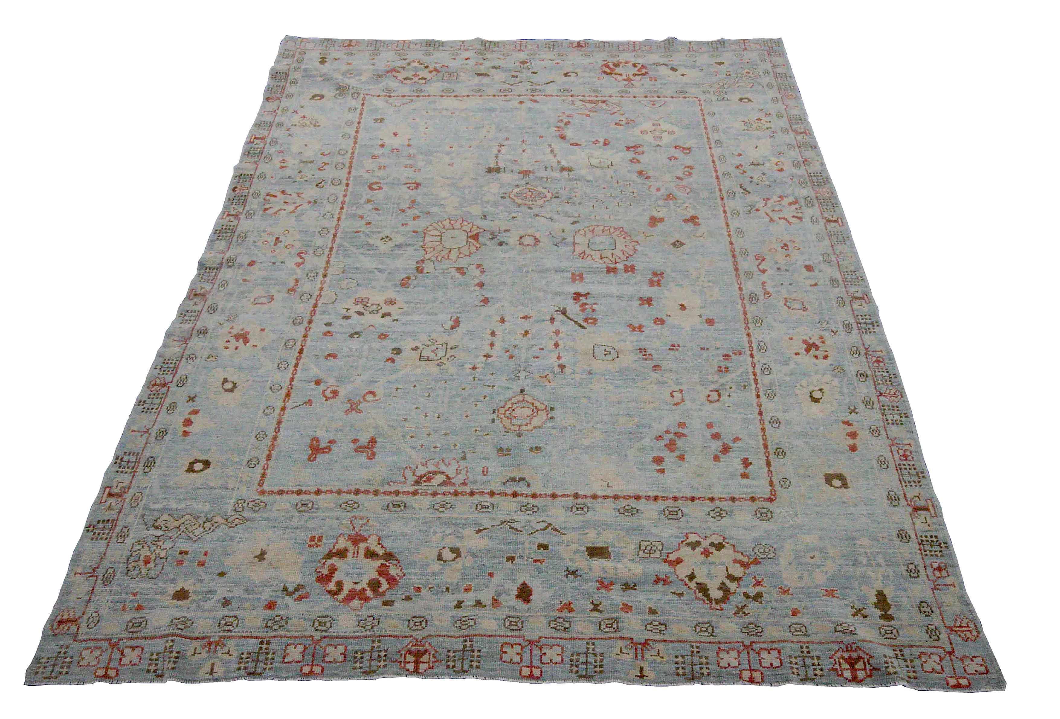 New Turkish rug made of handwoven sheep’s wool of the finest quality. It’s colored with organic vegetable dyes that are certified safe for humans and pets alike. It features floral details in ivory and red over an exquisite blue field. Flower