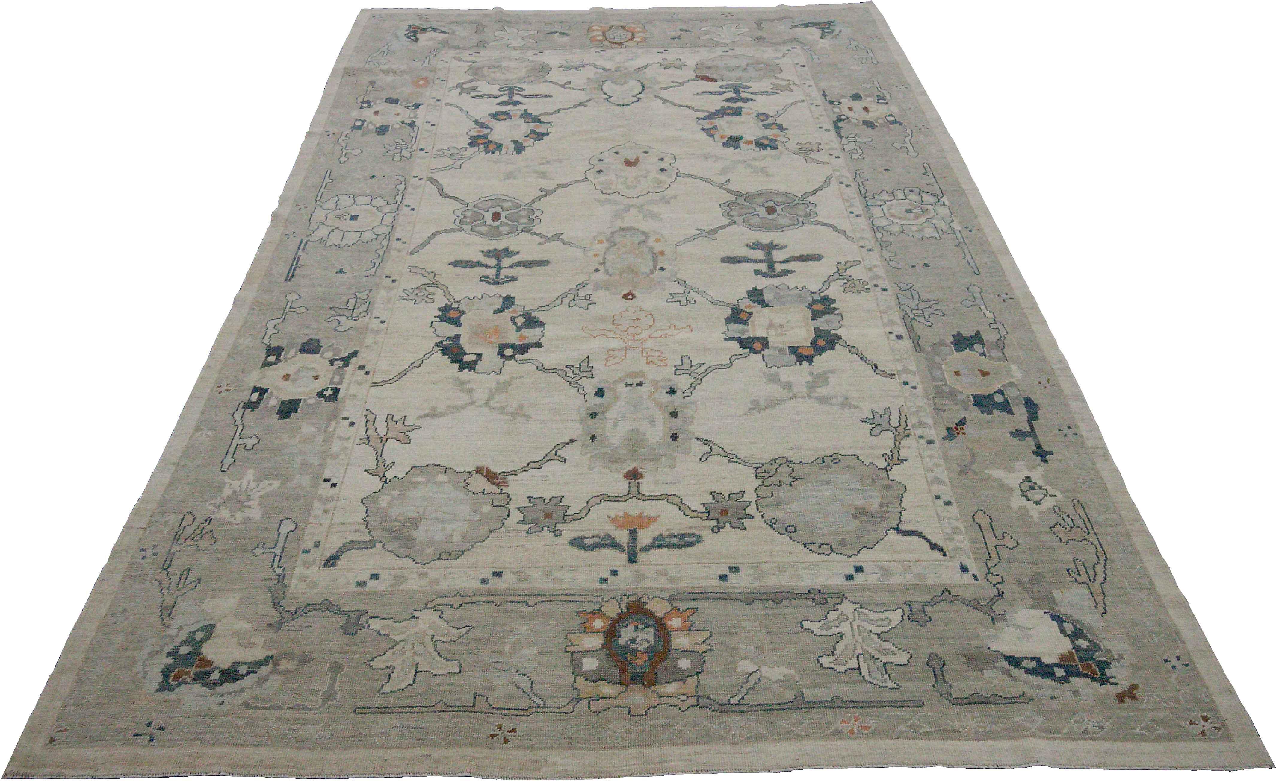 New Turkish rug made of handwoven sheep’s wool of the finest quality. It’s colored with organic vegetable dyes that are certified safe for humans and pets alike. It features floral details in navy blue and gray over an exquisite ivory field. Flower