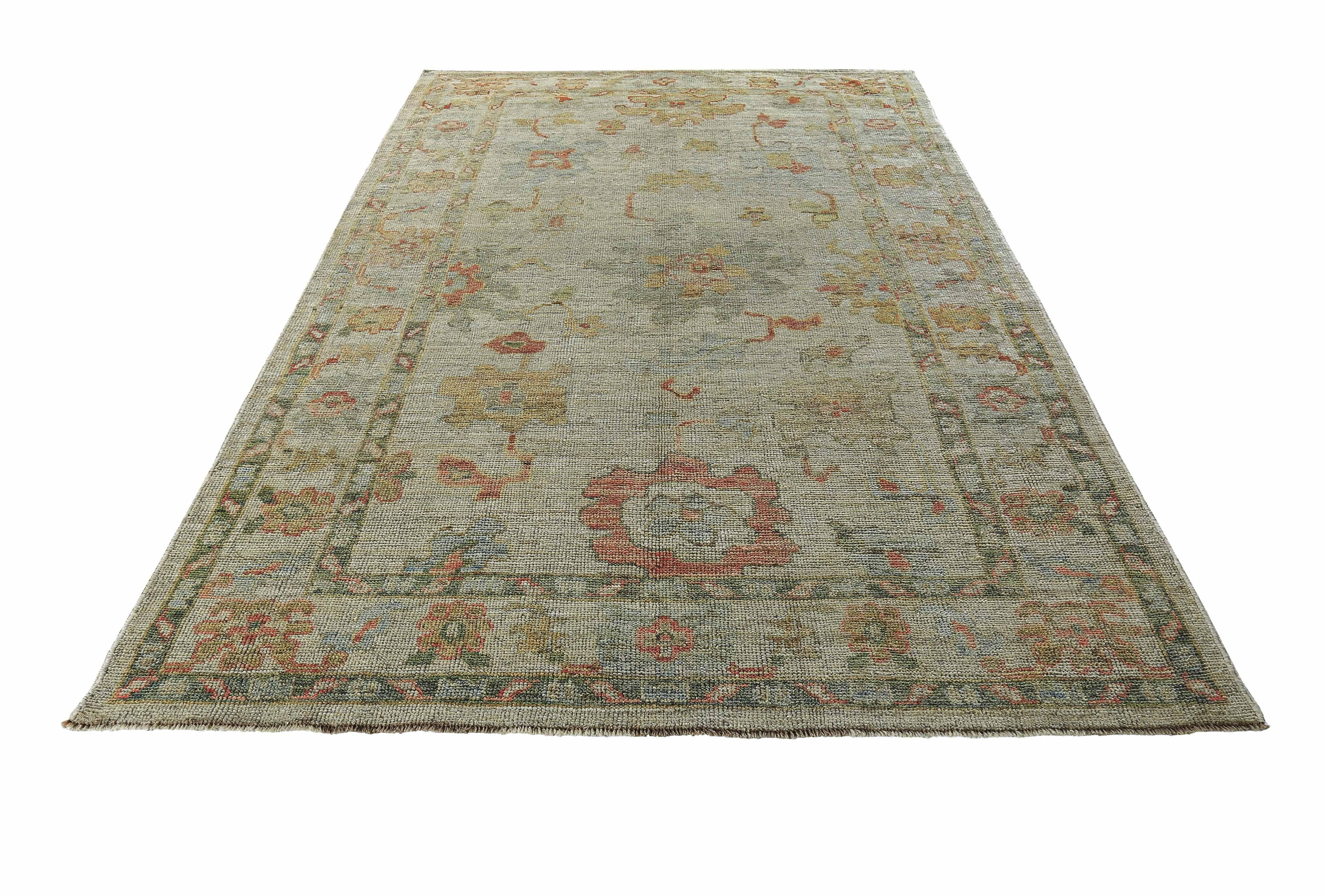 New Turkish rug made of handwoven sheep’s wool of the finest quality. It’s colored with organic vegetable dyes that are certified safe for humans and pets alike. It features pink and golden flower heads adorning an elegant ivory field. Flower