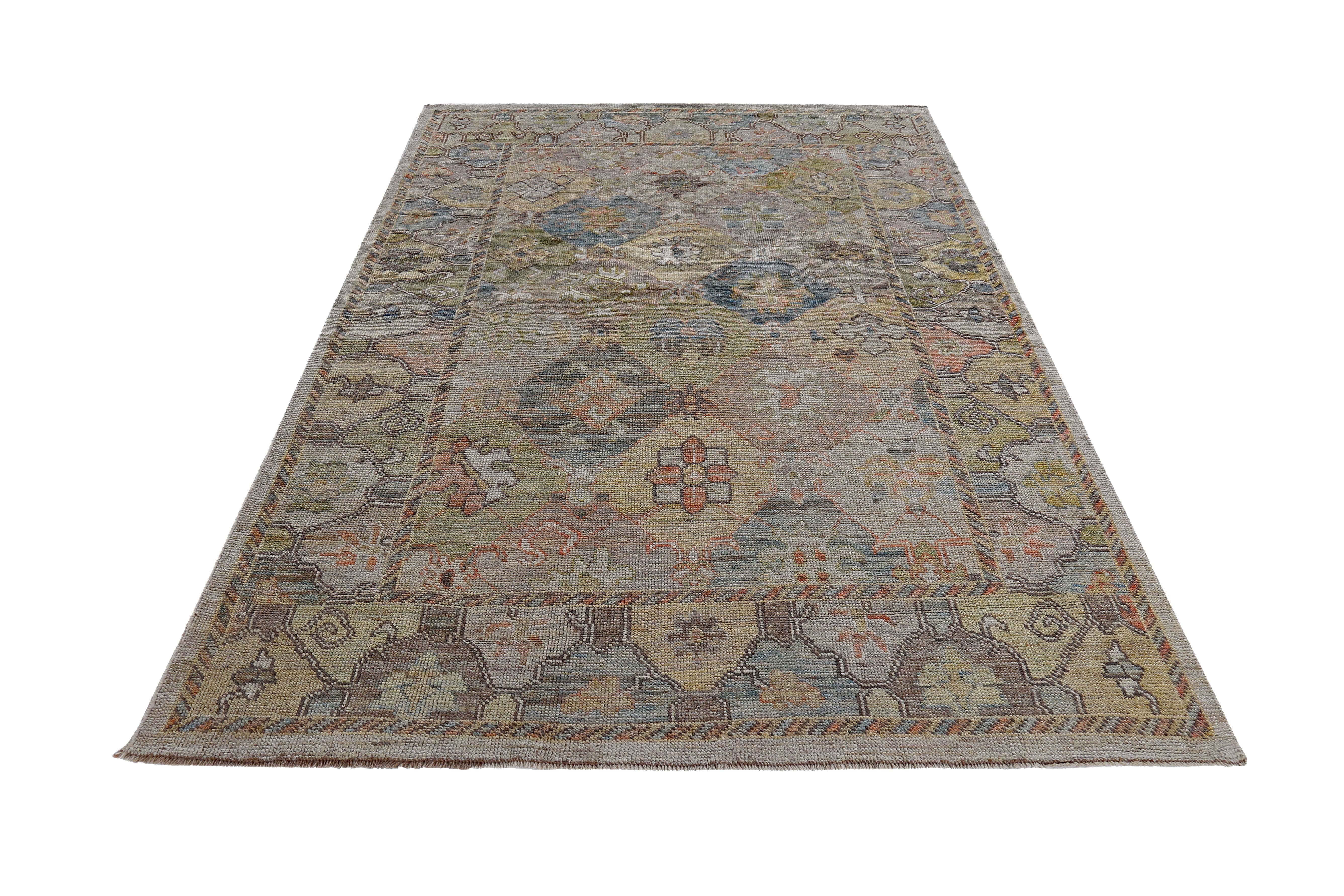 New Turkish rug made of handwoven sheep’s wool of the finest quality. It’s colored with organic vegetable dyes that are certified safe for humans and pets alike. It features floral details in yellow, blue and green over a beige field. Flower