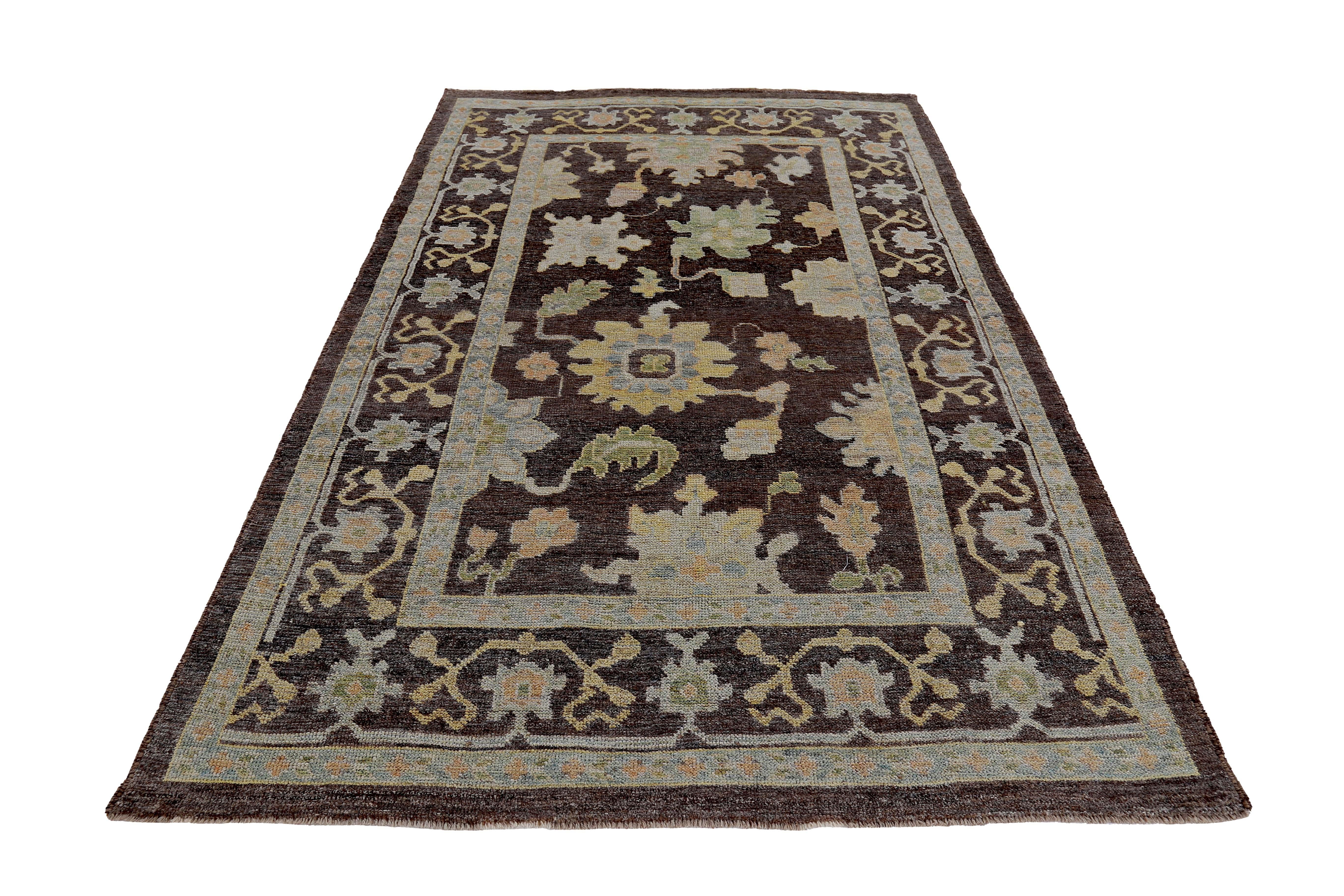 New Turkish rug made of handwoven sheep’s wool of the finest quality. It’s colored with organic vegetable dyes that are certified safe for humans and pets alike. It features floral details in yellow and green over a brown field. Flower patterns are
