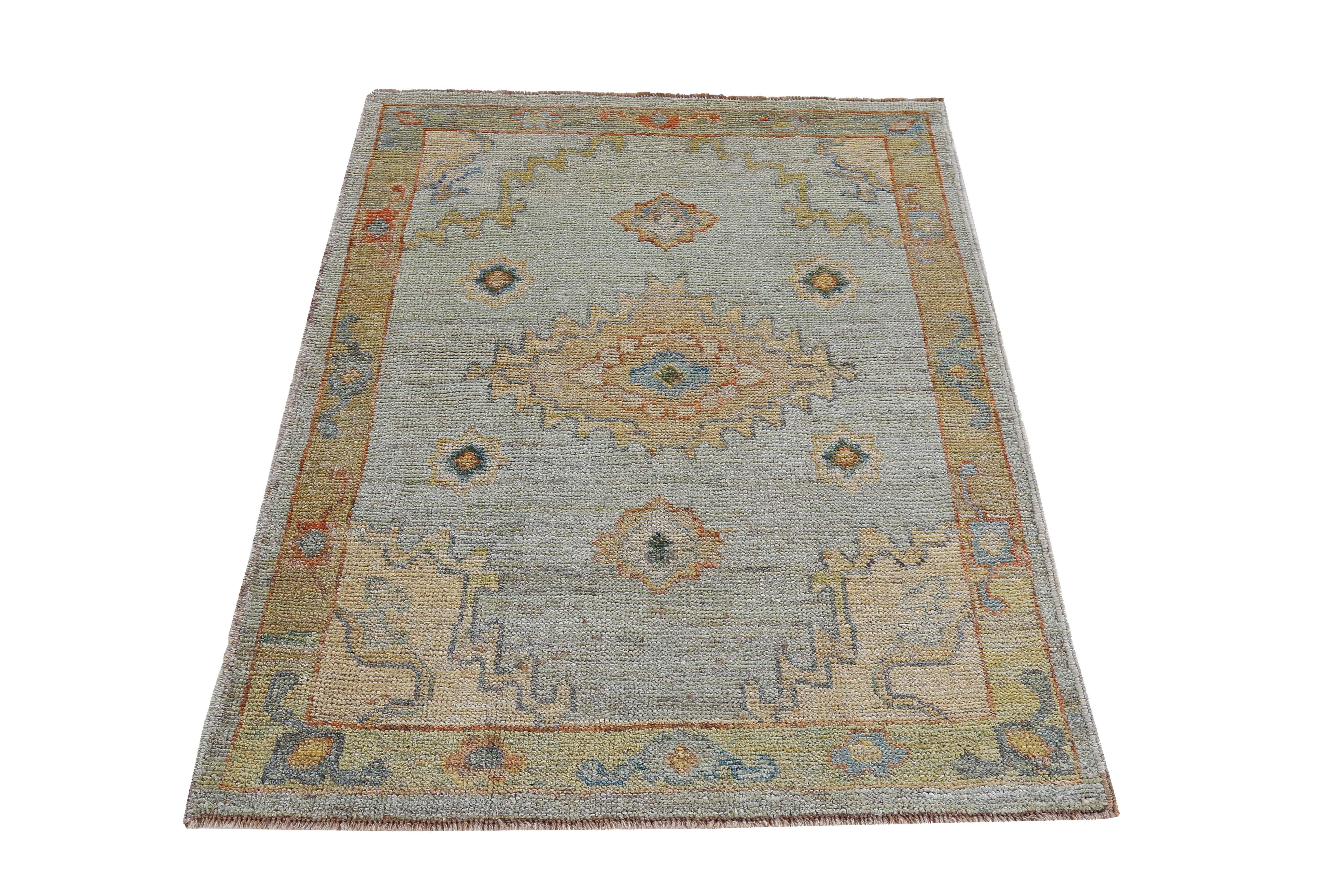 New Turkish rug made of handwoven sheep’s wool of the finest quality. It’s colored with organic vegetable dyes that are certified safe for humans and pets alike. It features floral details in yellow, orange and green over a blue field. Flower