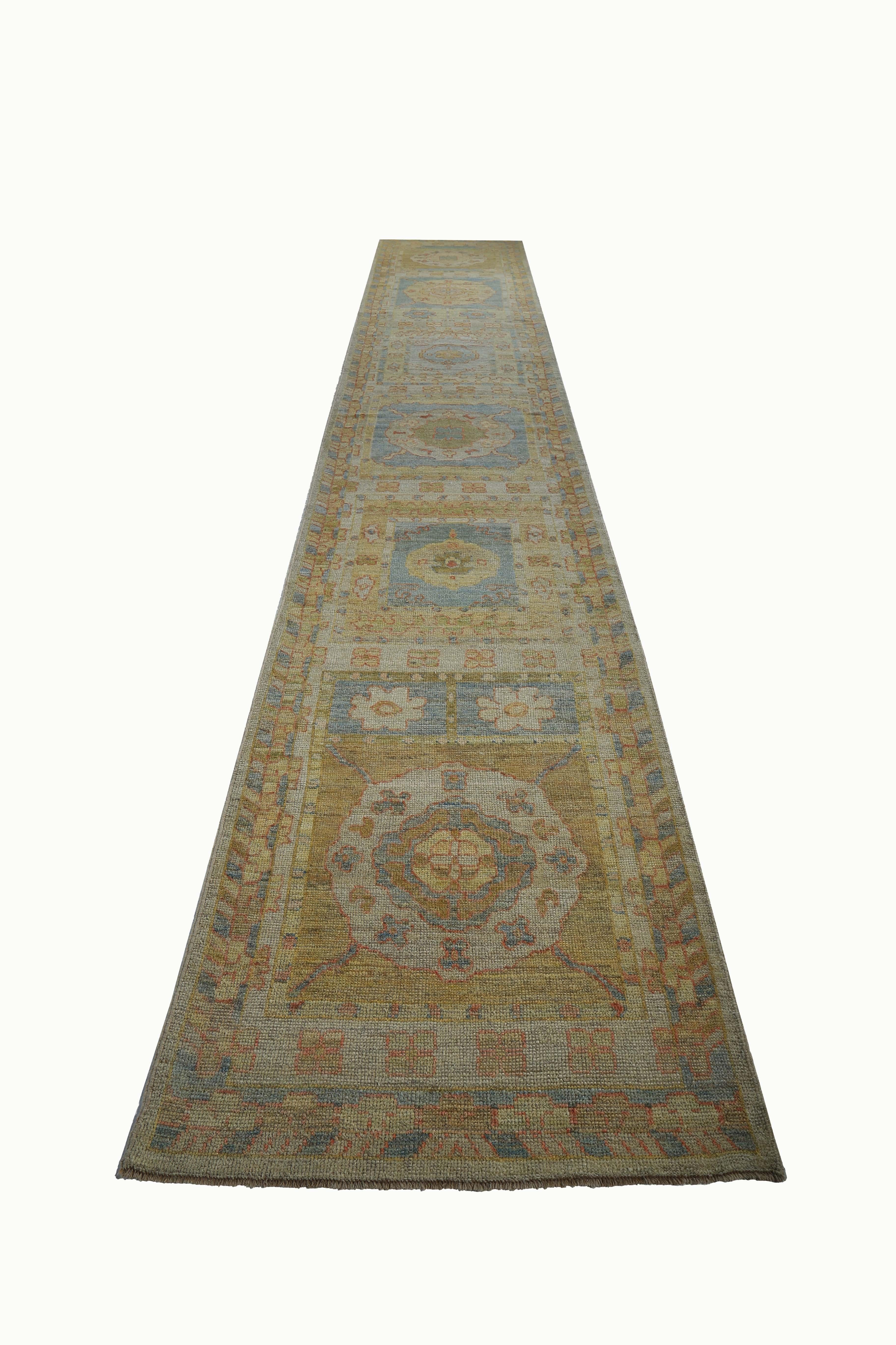 New Turkish rug made of handwoven sheep’s wool of the finest quality. It’s colored with organic vegetable dyes that are certified safe for humans and pets alike. It features floral details in blue and green over a yellow field. Flower patterns are