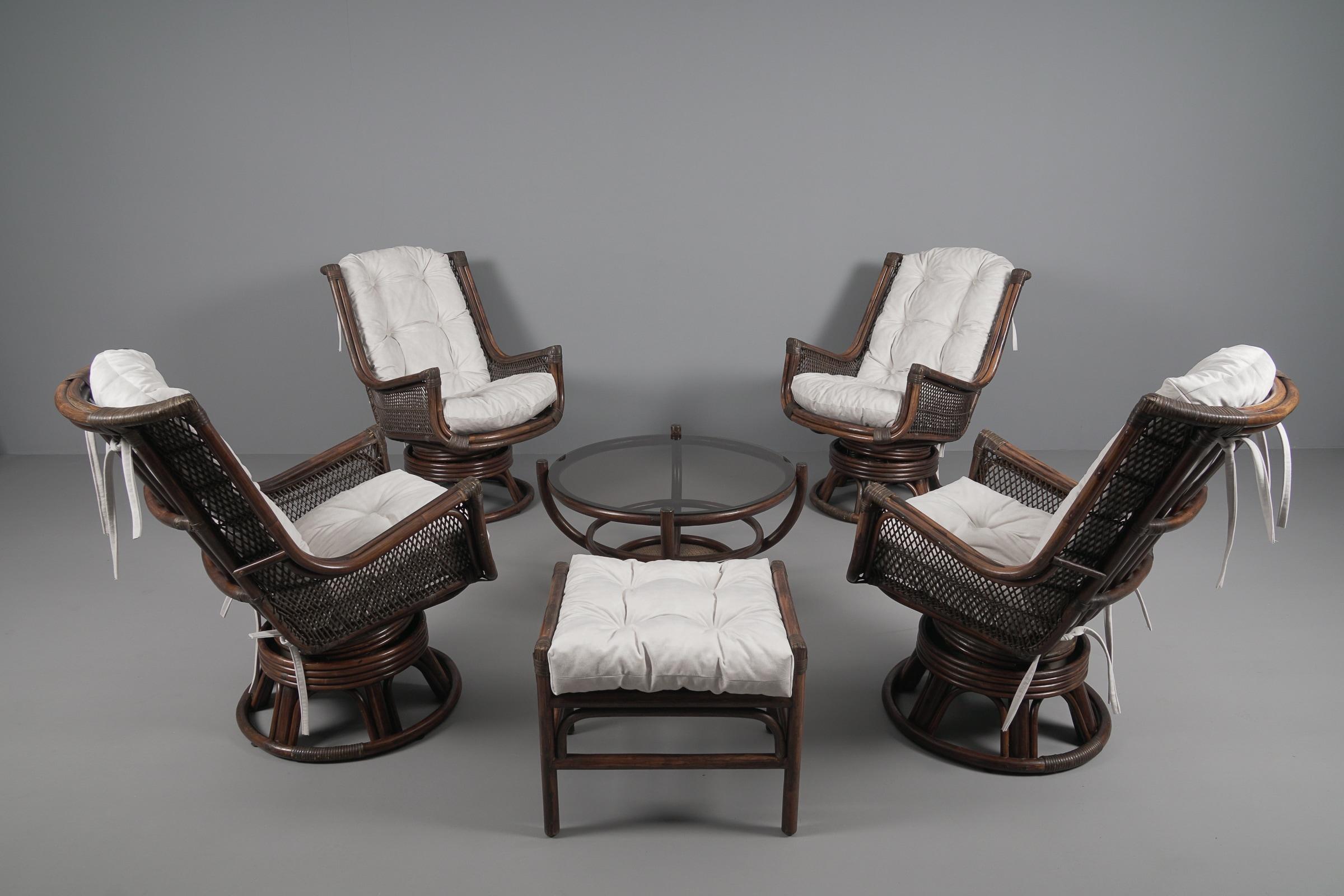 New upholstered rattan seating set consisting of 4x swivel and tilt armchairs 1x stool 1x coffee table, 1960s Italy.

The armchairs and the stool have been newly upholstered. A uniquely beautiful set from the 1960s from Italy.

They armchairs