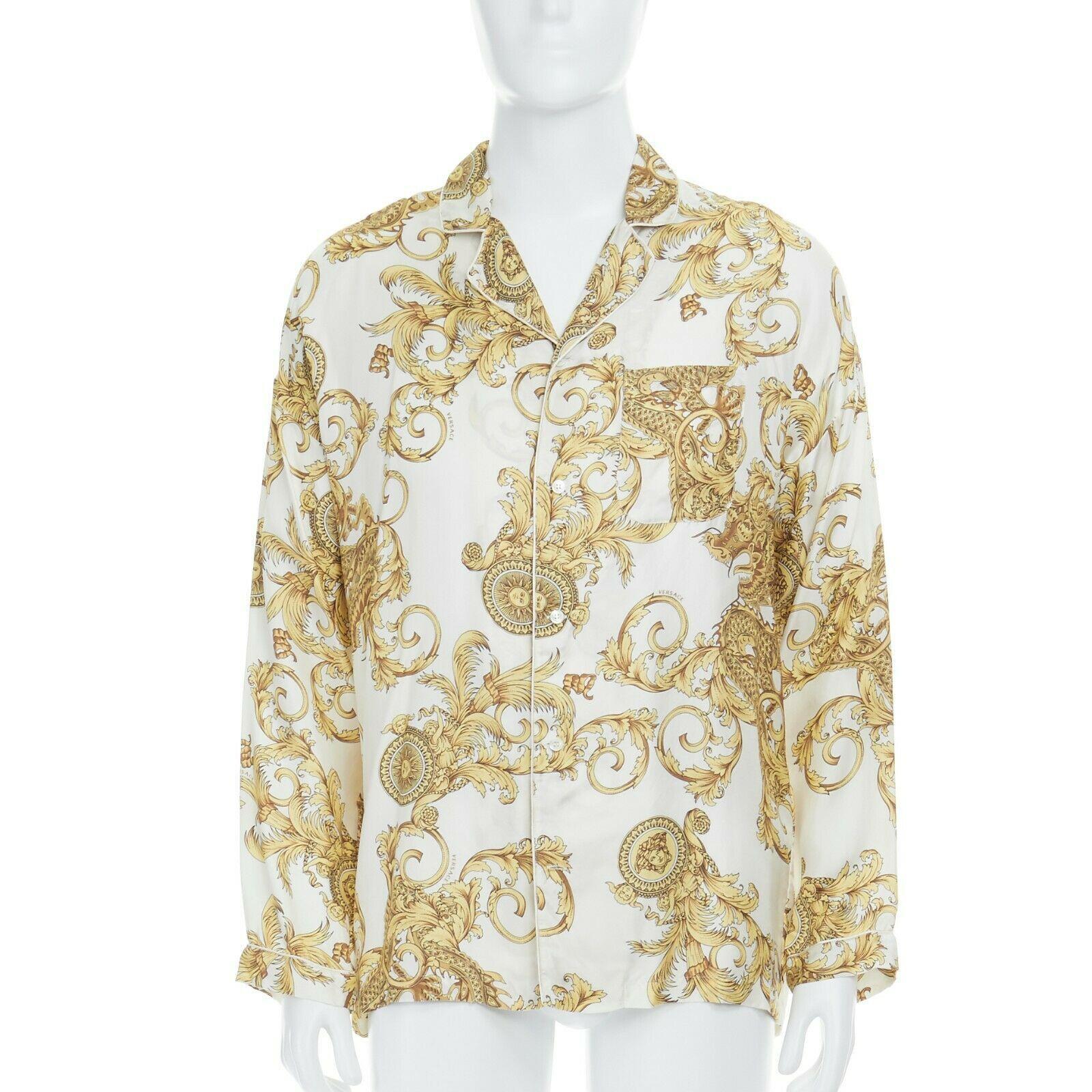 new VERSACE 100% silk white gold dragon Medusa baroque pyjama fit shirt IT3 XS
VERSACE UNDERWEAR
100% silk. 
White base with gold baroque floral print. 
Dargon and Medusa head print. Spread notched collar. 
Piping along collar. Dropped shoulder.