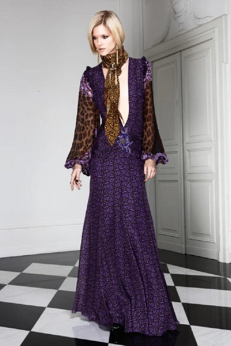New Versace Silk Mixed Print Embellished Dress Gown
Italian size - 38
Purple/brown baroque floral-and-crown print on leopard-print chiffon.
Deep plunging V-neck. Dramatic, sheer balloon sleeves. 
Ruffle-trimmed shoulders and crystal embellished