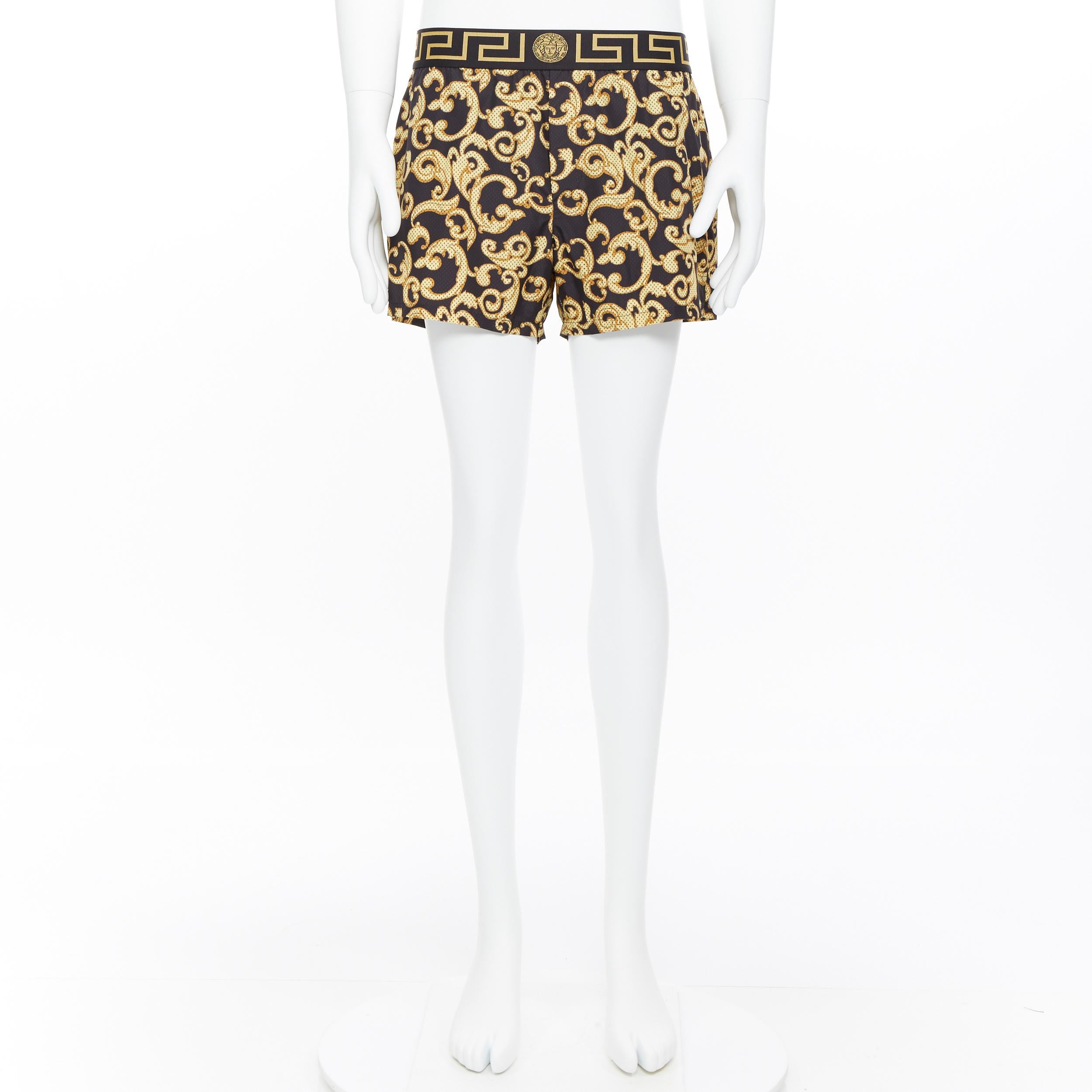 black and gold versace shorts