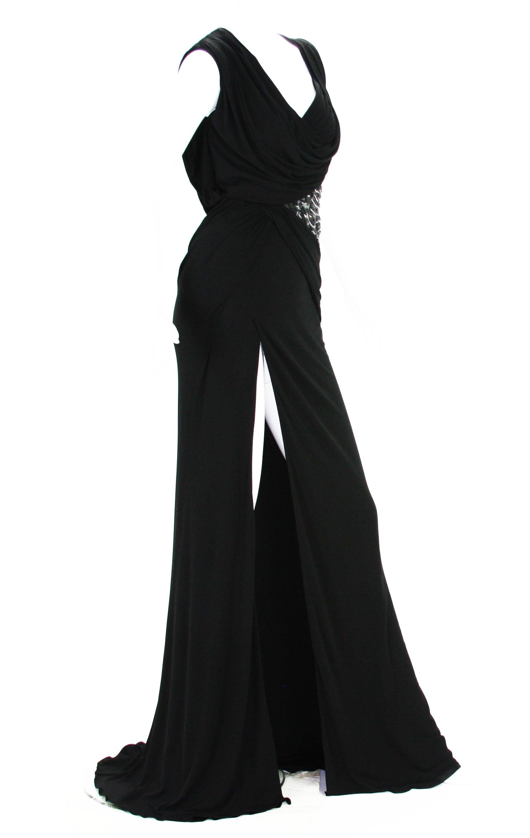 New Versace Black Jersey Long Dress Gown
Designer size 40 -  US 6
Black Jersey, High Side Slit, Build in Leotard Bottom Underlay, Side Zip Closure, Fully Lined in Same Jersey Fabric.
Leather, Beads and Sequins Embellishment Over the Tulle.
Made in