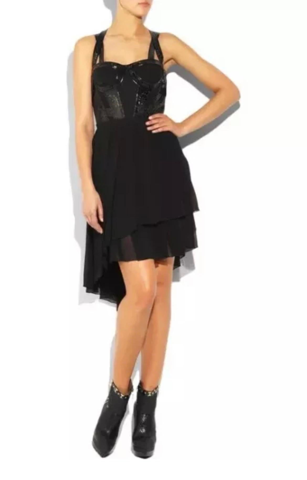 VERSACE
Create a scene at cocktail hour in Versace’s black silk-chiffon underwired mini dress with laser-cut patent-leather detail. 
This black silk-chiffon pleated mini dress with patent-leather detail has two cross-over straps with tulle and