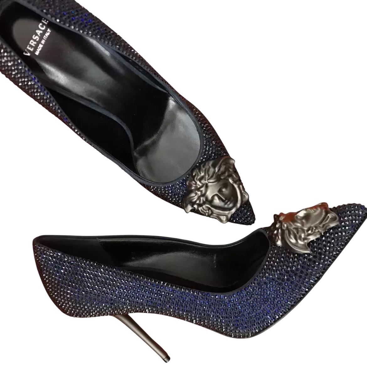 VERSACE PALAZZO PUMPS
Blue Sapphire crystal shoes from the Palazzo line, with stiletto heel.
DETAILS:
Closed toe
Medusa plaque
Content: 100% Leather (Lining and Sole) 
Color: Blue Sapphire
Heel: 4 inches
Size 39 - US 9
insole: 10 1/4