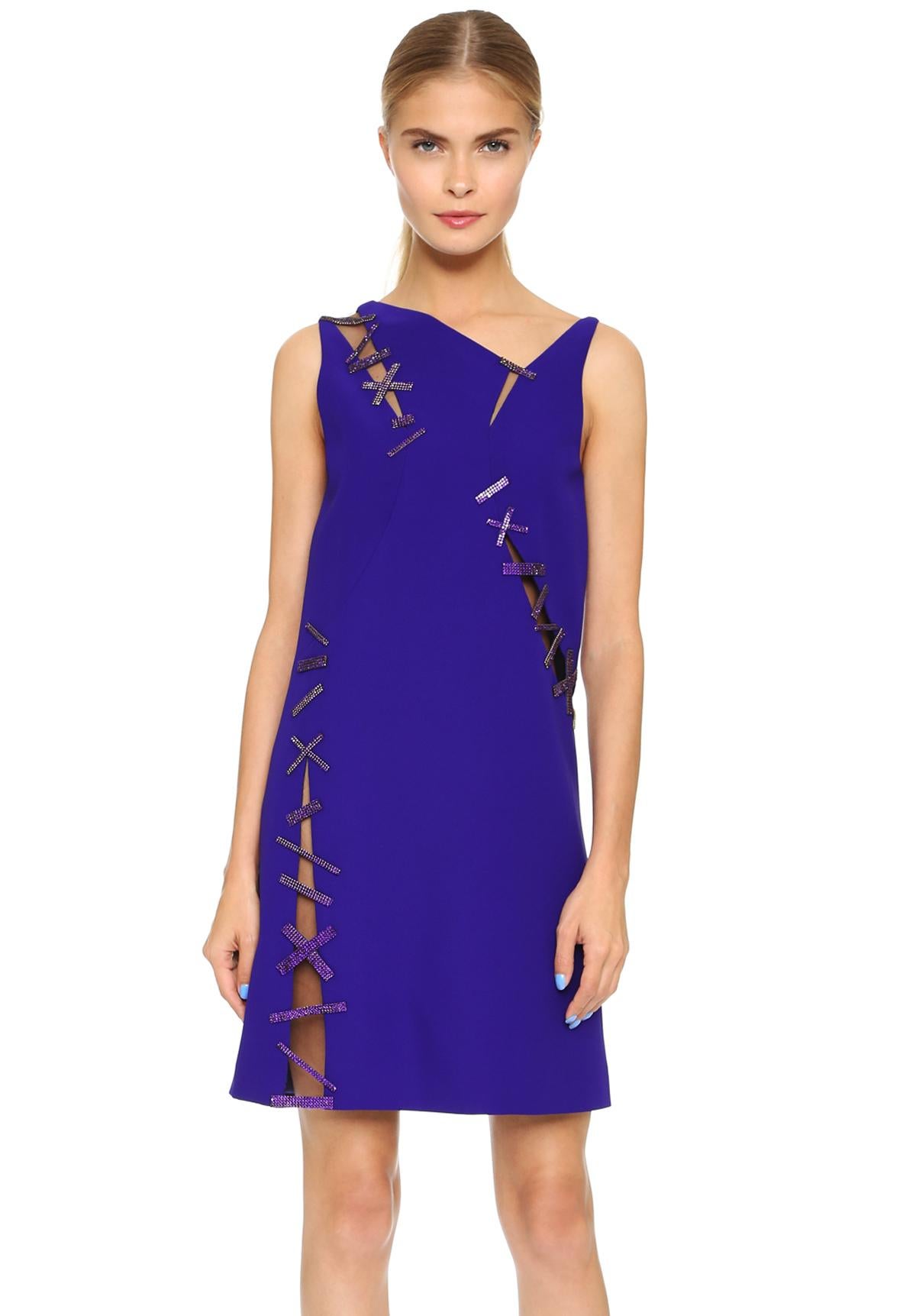 A Glamorous VERSACE Mini Cocktail  Dress
Italian size 38 - US 2
Purple Shimmering Swarovski Crystals Accent the Stitch Detailing at the Mesh-Trimmed Cut-Outs
The Sleek Shift Silhouette is Slashed to Reveal Slices of Skin
Asymmetrical Neckline,