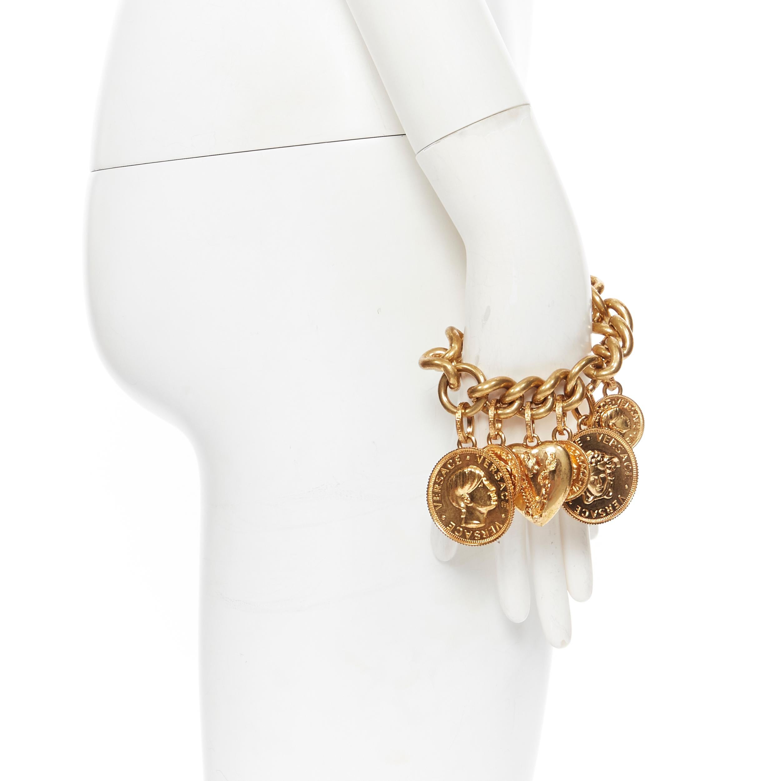 new VERSACE gold plated Medusa medallion coin V-Mine Heart charm chunky bracelet
Brand: Versace
Designer: Donatella Versace
Collection: 2019
Model Name / Style: Chunky bracelet
Material: Metal
Color: Gold
Pattern: Solid
Closure: Clasp
Extra Detail:
