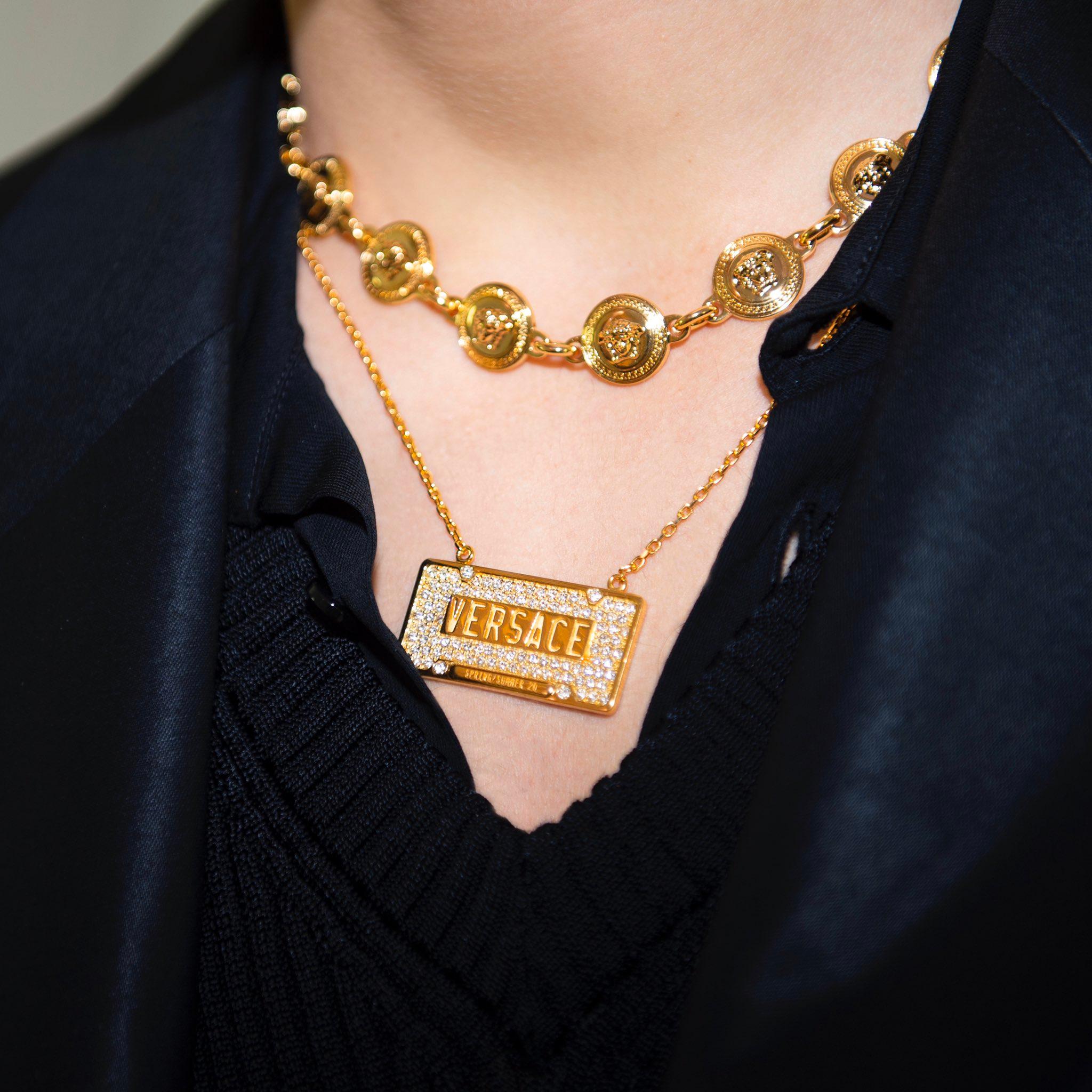 new VERSACE gold tone metal crystal embellished ID dog tag Medusa necklace 
Reference: TGAS/C00152 
Brand: Versace 
Designer: Donatella Versace 
Material: Metal 
Color: Gold 
Pattern: Solid 
Closure: Lobster 
Extra Detail: Versace crystal