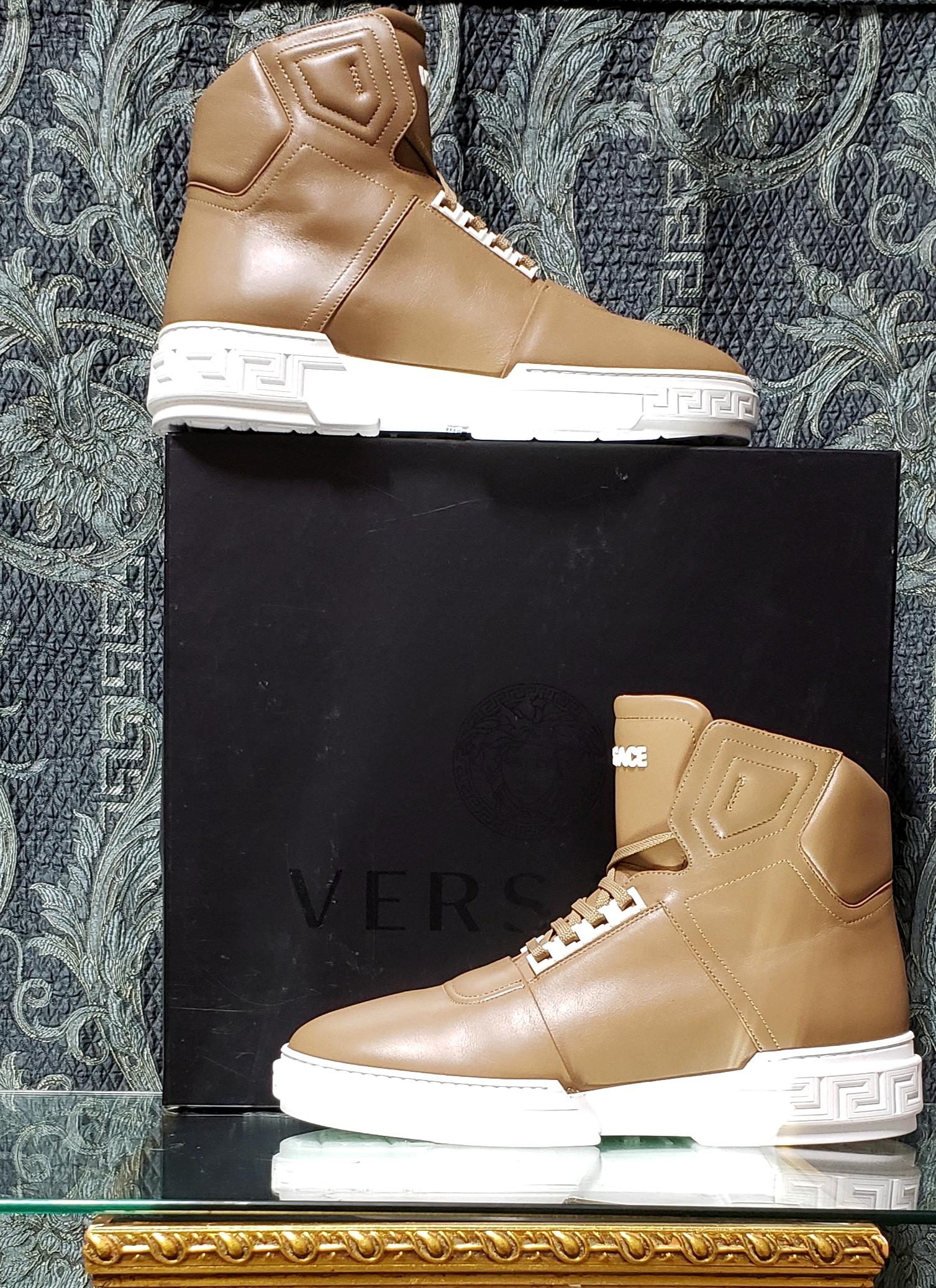 VERSACE 



Mocha high - top sneakers from Versace. 

Made of leather.

 Decorated with a perforation. 



White rubber sole with embossed Greek pattern.



Content: 100% Leather, Rubber sole


 Italian size is 44 - US 11
 insole:11 1/4