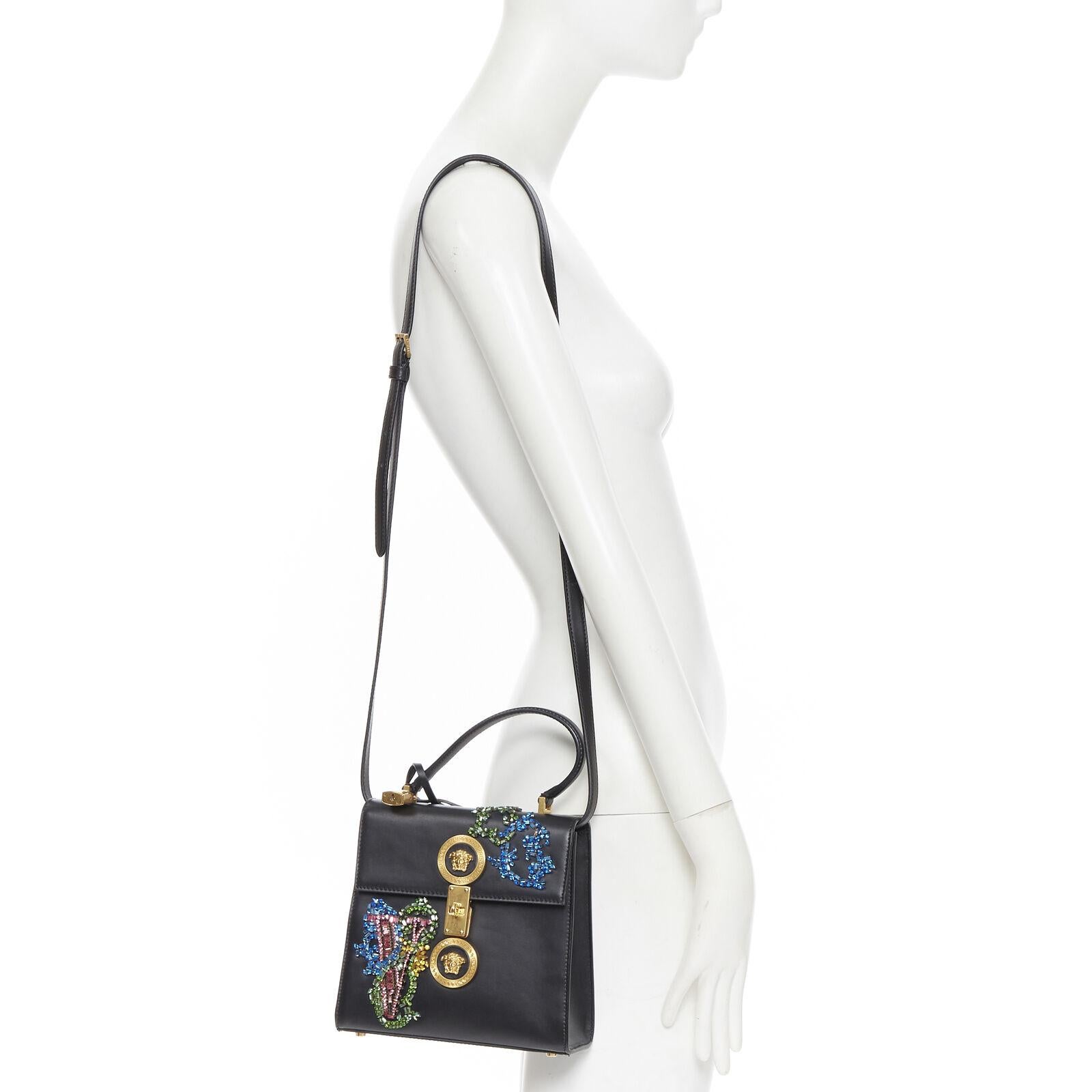 VERSACE

Icon Flap black baroque Swarovski crystal embellished top handle bag
Brand: Versace
Designer: Donatella Versace
Collection: 2019
Model Name / Style: Icon
Material: Leather
Color: Black
Pattern: Solid
Closure: Turnlock
Lining material: