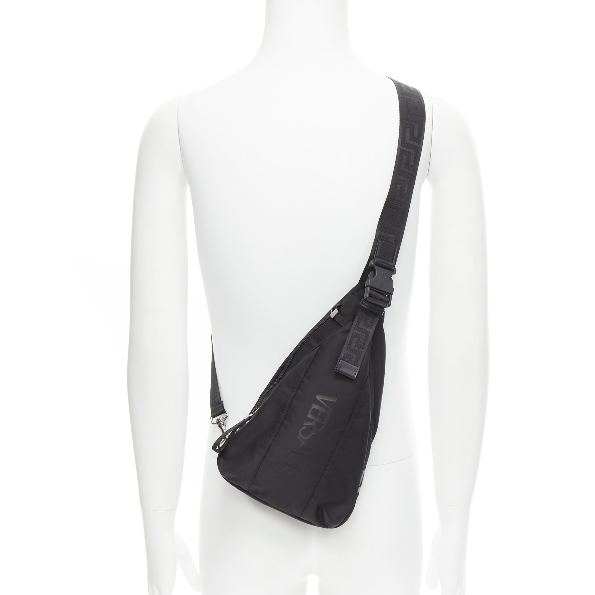 new VERSACE La Greca Vintage 90s Logo black nylon small sling backpack bag 
Reference: TGAS/C00356 
Brand: Versace 
Designer: Donatella Versace 
Model: 1002888 1A02180 2B77E 
Material: Nylon 
Color: Black 
Pattern: Solid 
Closure: Zip 
Extra Detail: