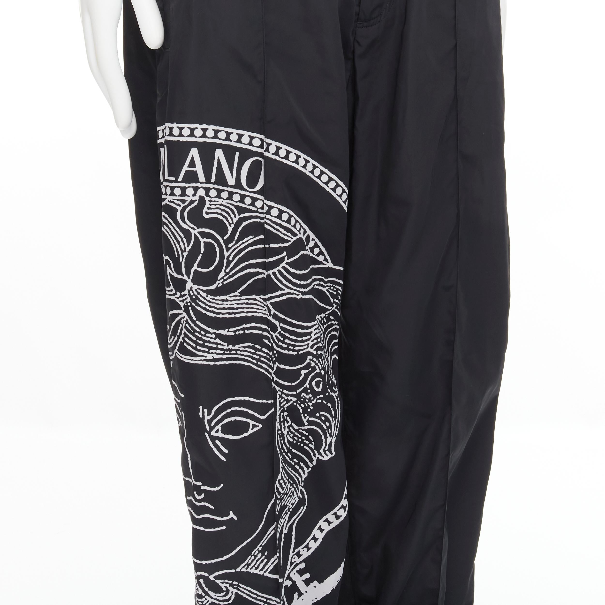 new VERSACE Medusa Big Logo print black nylon Y2K track pants IT50 L 
Reference: TGAS/C00545 
Brand: Versace 
Designer: Donatella Versace 
Material: Nylon 
Color: Black 
Pattern: Solid 
Closure: Elastic 
Extra Detail: Black nylon pants. Big Logo