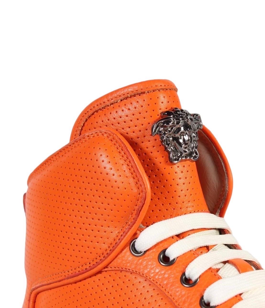 VERSACE 
Men's Orange Perforated Leather  High-Top Sneakers
Made in Italy      
Italian sizes: 41, 42, 43, 45
Brand new.