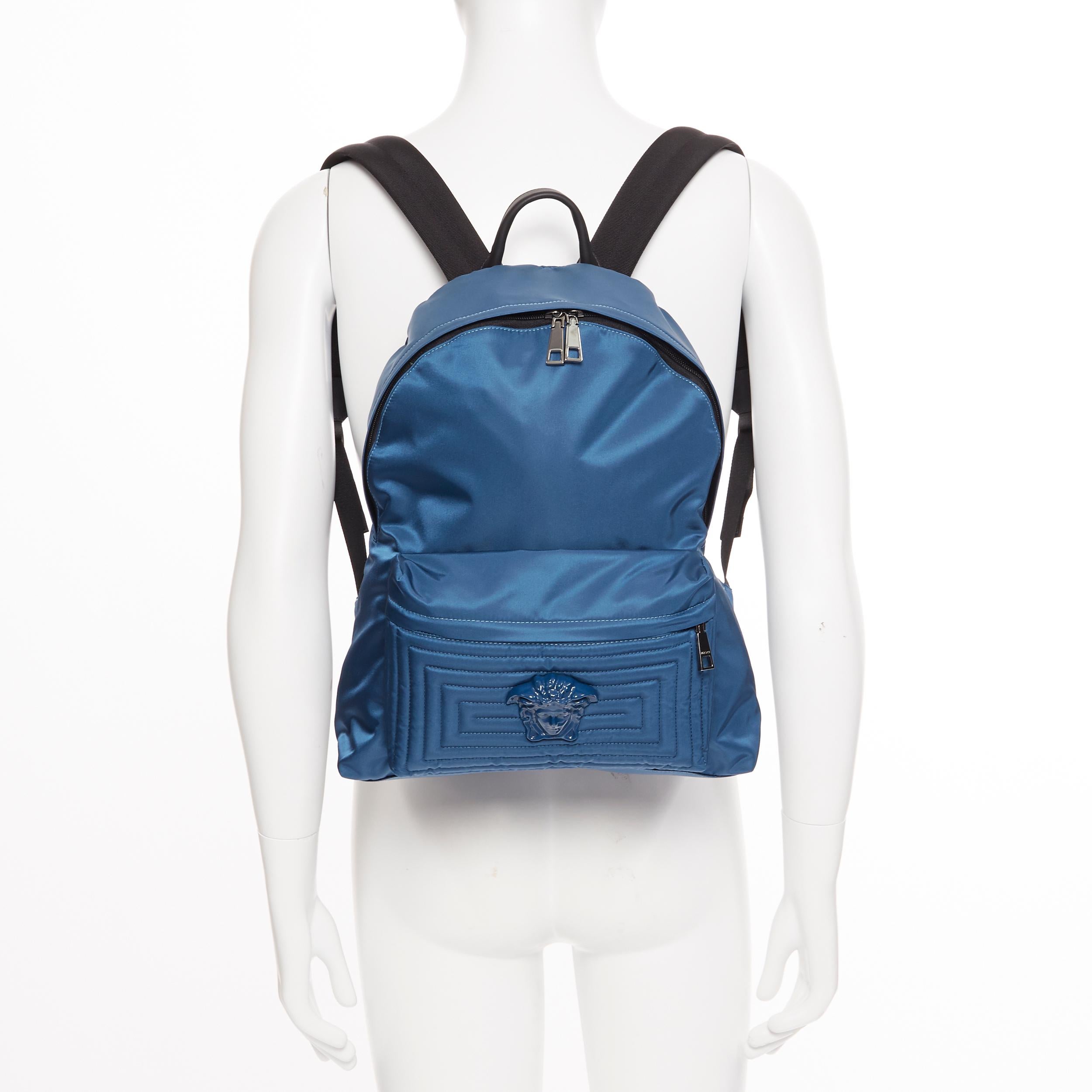new VERSACE Palazzo Medusa blue nylon Greca stitch front pocket backpack 
Brand: Versace
Designer: Donatella Versace
Model Name / Style: Palazzo nylon backpack
Material: Nylon; leather handle
Color: Blue
Pattern: Solid
Closure: Zip
Lining material: