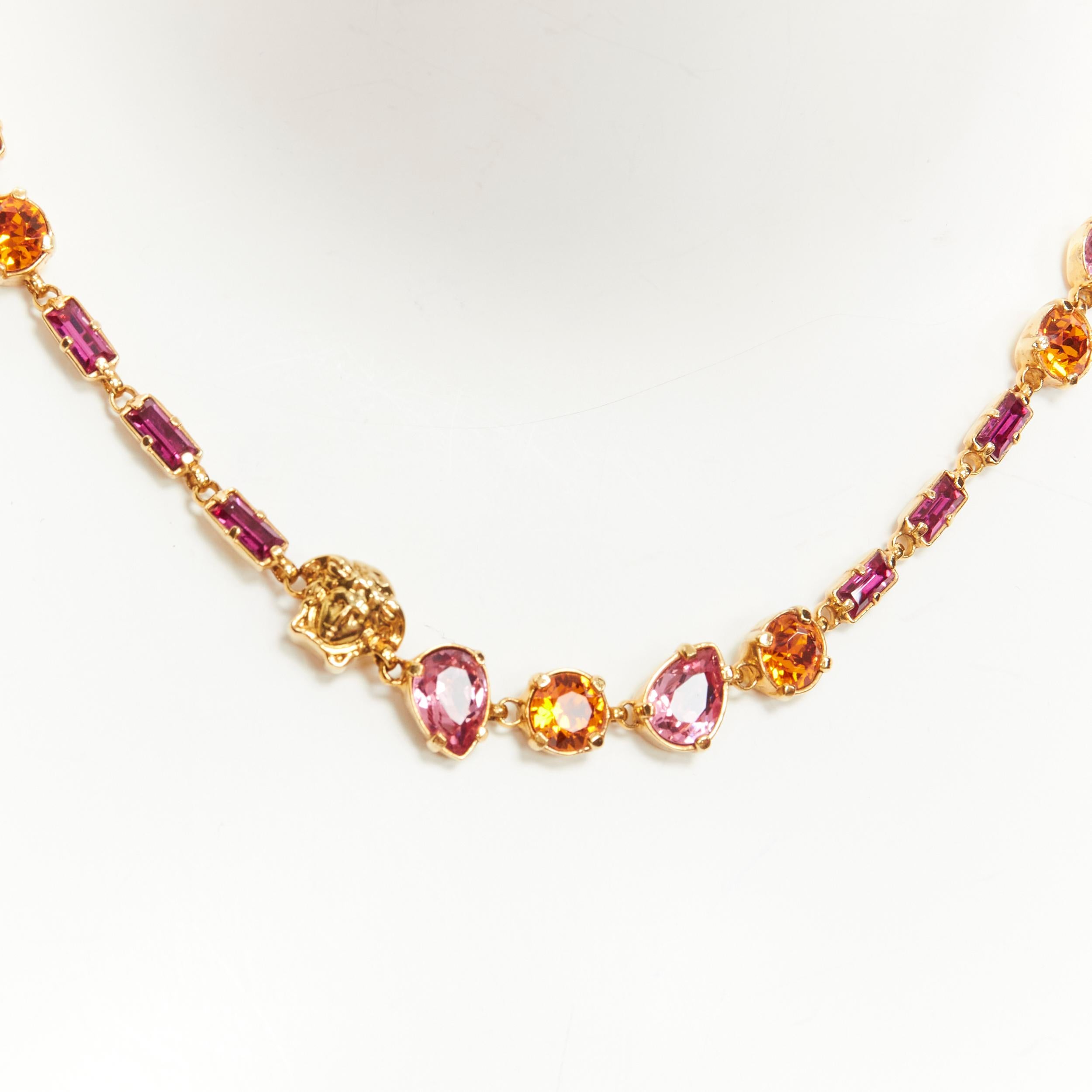 new VERSACE pink orange rhinestone crystal jewel Medusa charm short necklace 
Reference: TGAS/C00230 
Brand: Versace Designer: Donatella Versace 
Material: Metal 
Color: Gold 
Pattern: Solid 
Closure: Lobster 
Extra Detail: Mixed shaped jewel