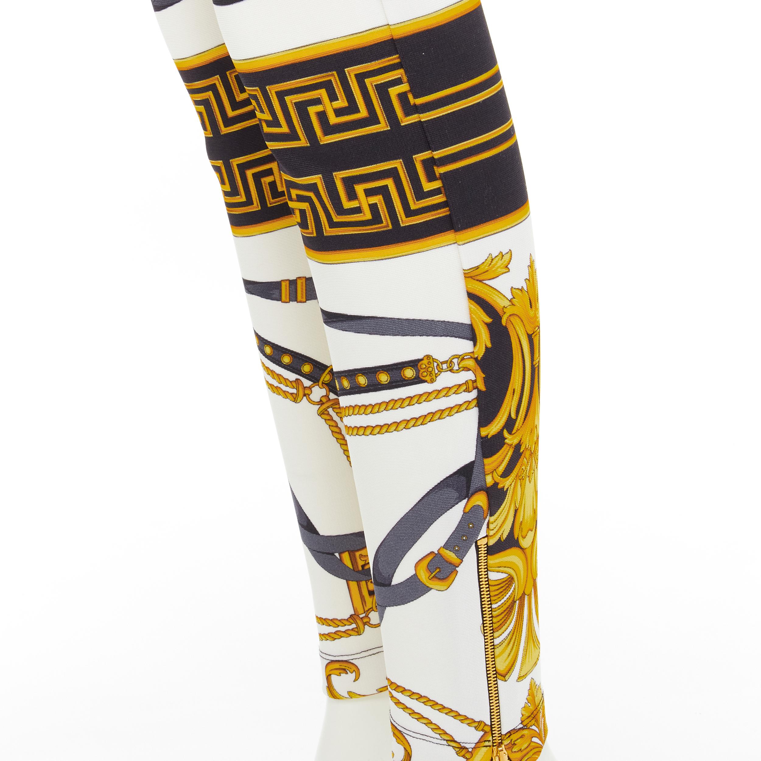 new VERSACE Rodeo Barocco black gold baroque harness stretchy leggings IT44 L 
Reference: TGAS/C01026 
Brand: Versace 
Designer: Donatella Versace 
Collection: Rodeo Barocco 
Material: Viscose 
Color: Gold 
Pattern: Floral 
Closure: Zip 
Extra