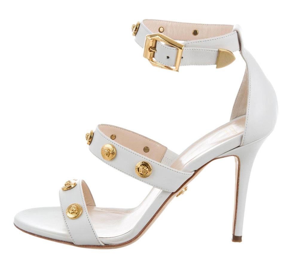 New Versace Signature Medusa White Leather Shoes Sandals
Designer size 40 - US 10
100% Leather, Gold-tone Metal Medusa Medallion Studs, Buckled Ankle-strap, Leather Sole and Lining.
Leather Covered High Heel  - 4 inches 
Made in Italy
New with