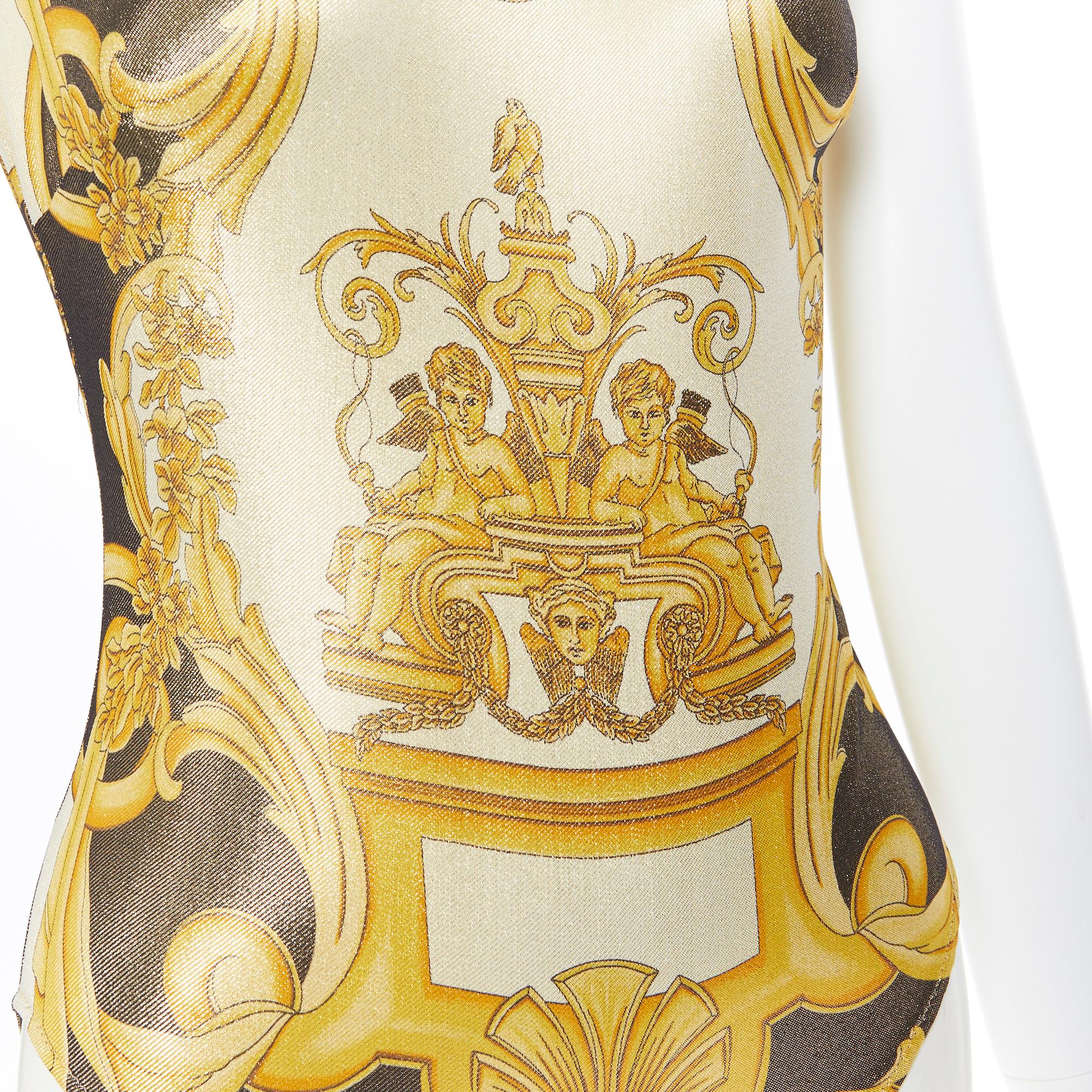 new VERSACE Tribute SS18 Runway Baroque Cherub gold black lurex bodysuit IT38 XS
Brand: Versace
Designer: Donatella Versace
Collection: SS2018
Model Name / Style: Bodysuit top
Material: Polyamide blend
Color: Gold, black
Pattern: Floral
Closure: