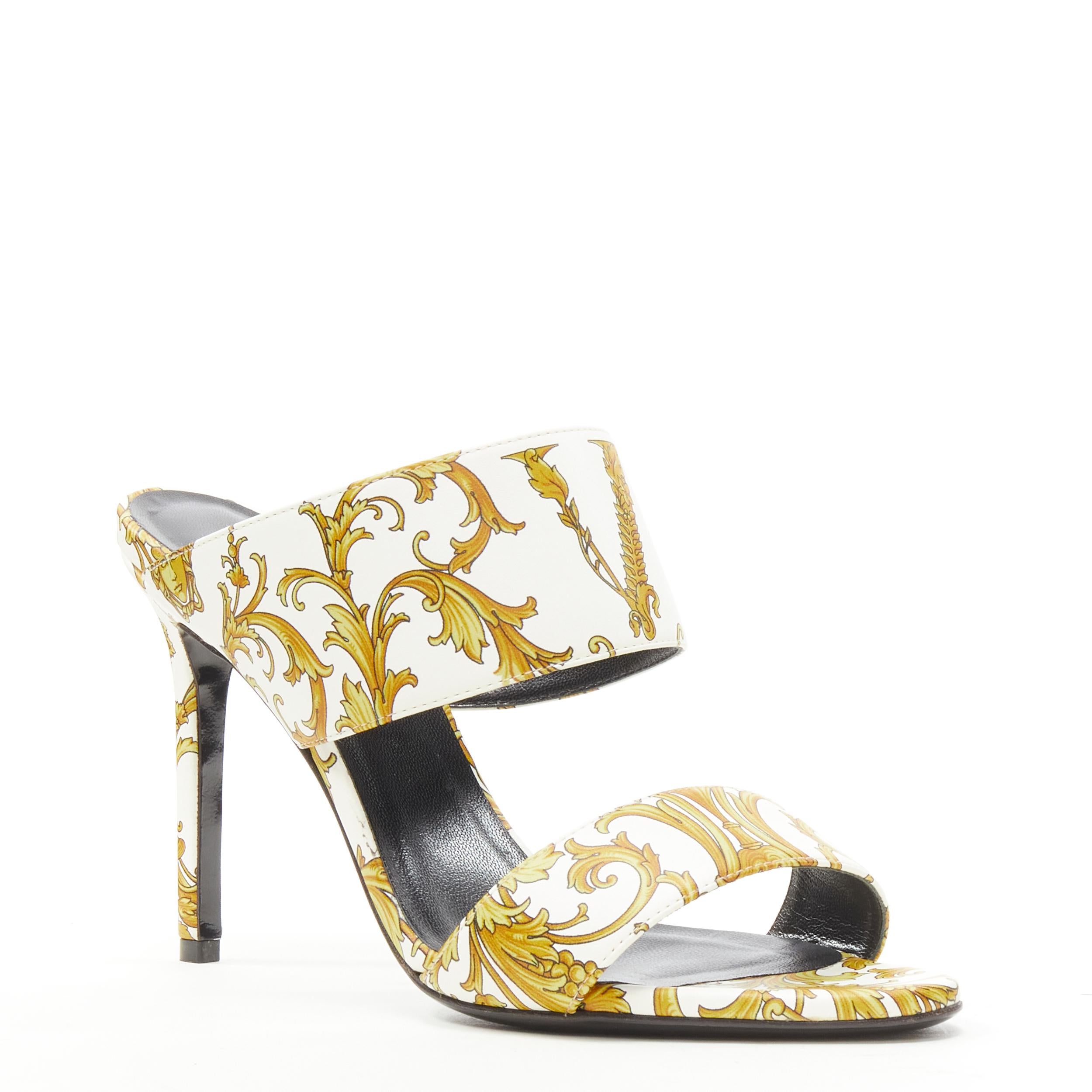new VERSACE Virtus Barocco white gold print strappy mule heel EU38 
Reference: TGAS/C00054 
Brand: Versace 
Designer: Donatella Versace 
Collection: Virtus Barocco 
Material: Leather 
Color: White 
Pattern: Floral 
Extra Detail: Genuine leather.