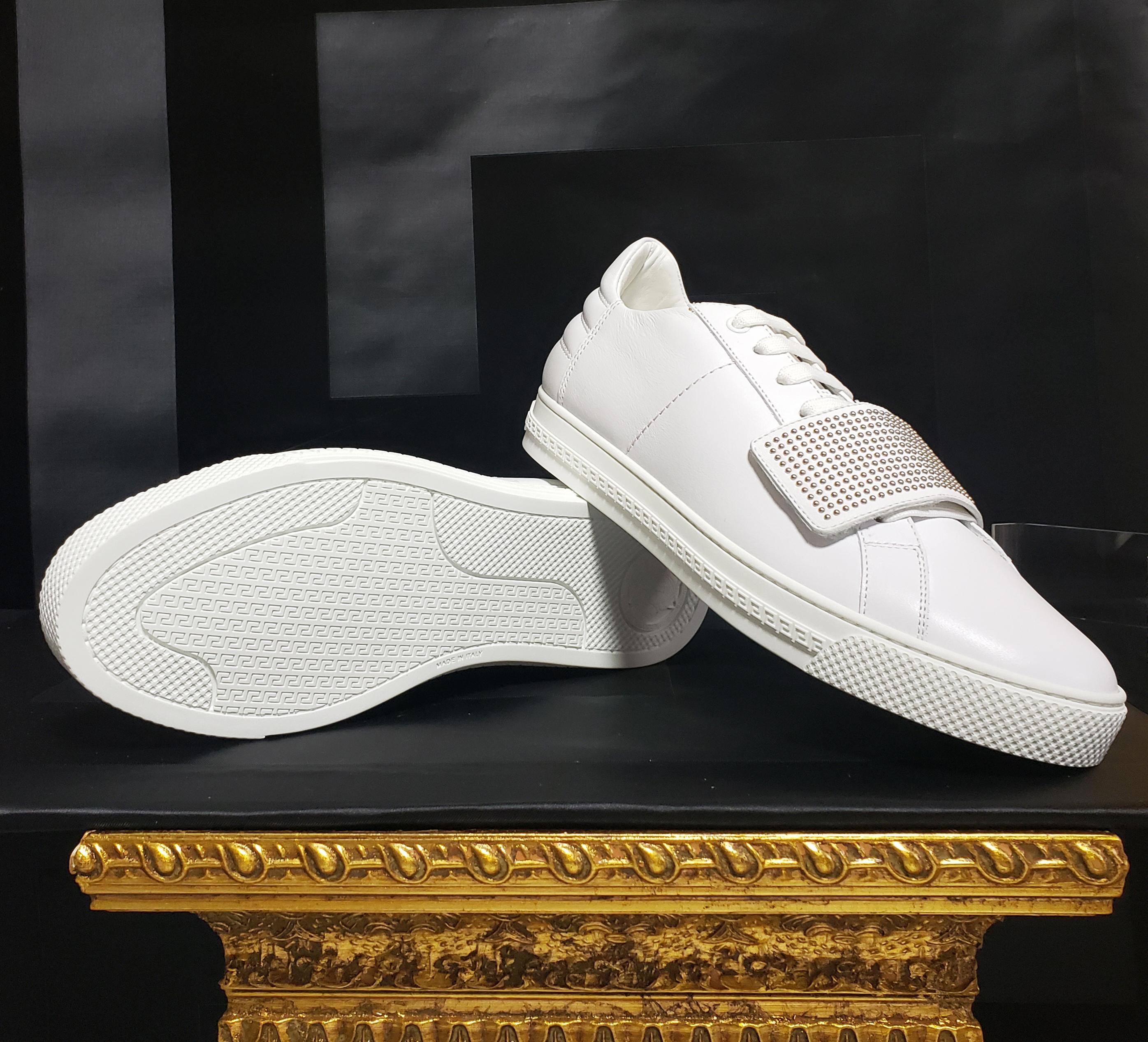 VERSACE 

 Sneakers


White leather sneakers with studded buckle. Greek pattern sole. Lace-up



Content: leather

Made in Italy
       Italian size is 40 - US 7

Brand new, with tags. Comes with Versace box

 100% authentic guarantee 

      