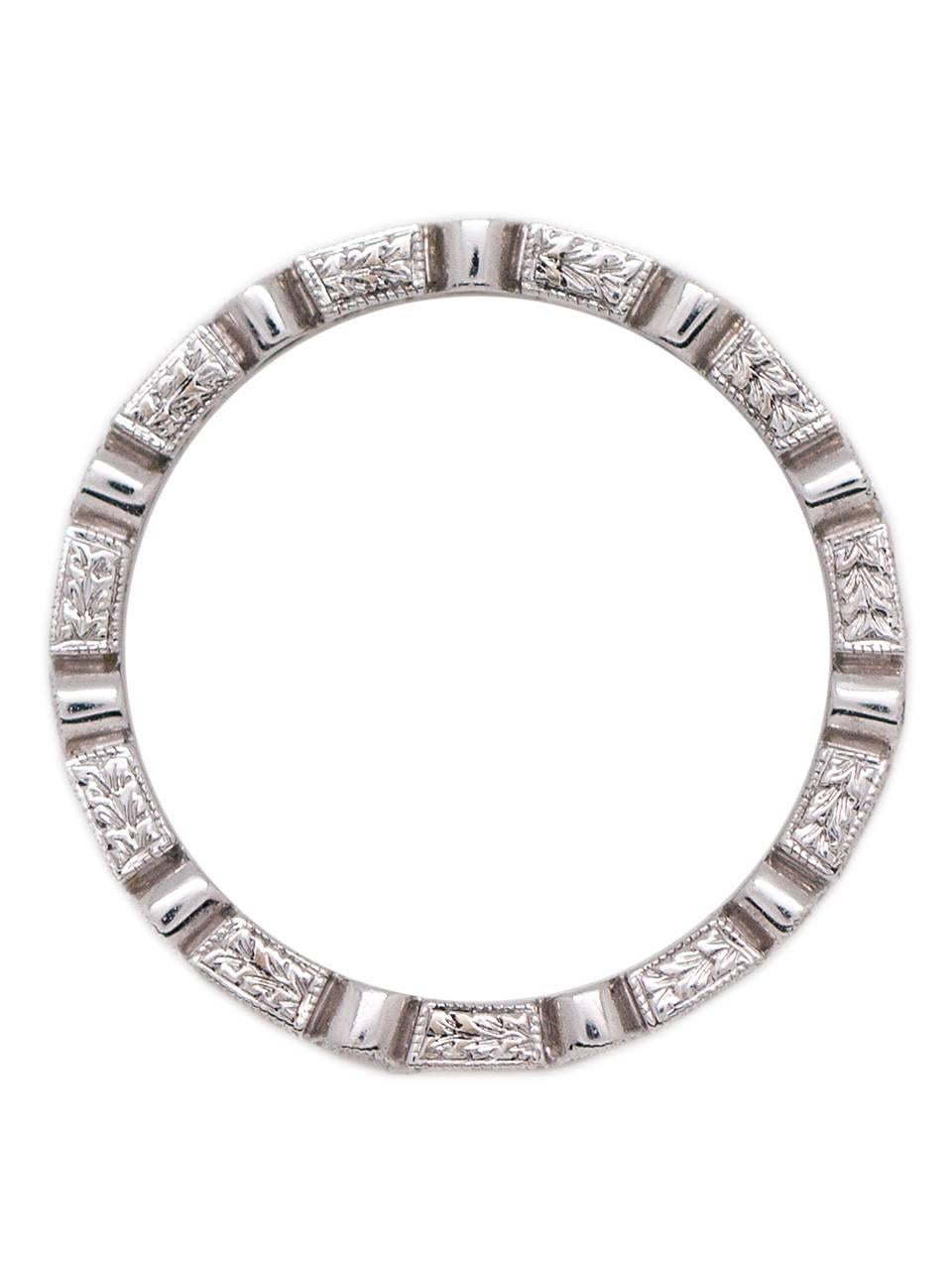 Lovely 18K white gold bezel-set diamond eternity band set with alternating round and baguette cut stones, with a total weight of approximately 0.71ct, VS-SI/G-H. The stunningly bright diamonds are accented by a double milgrain (beaded) edge, with