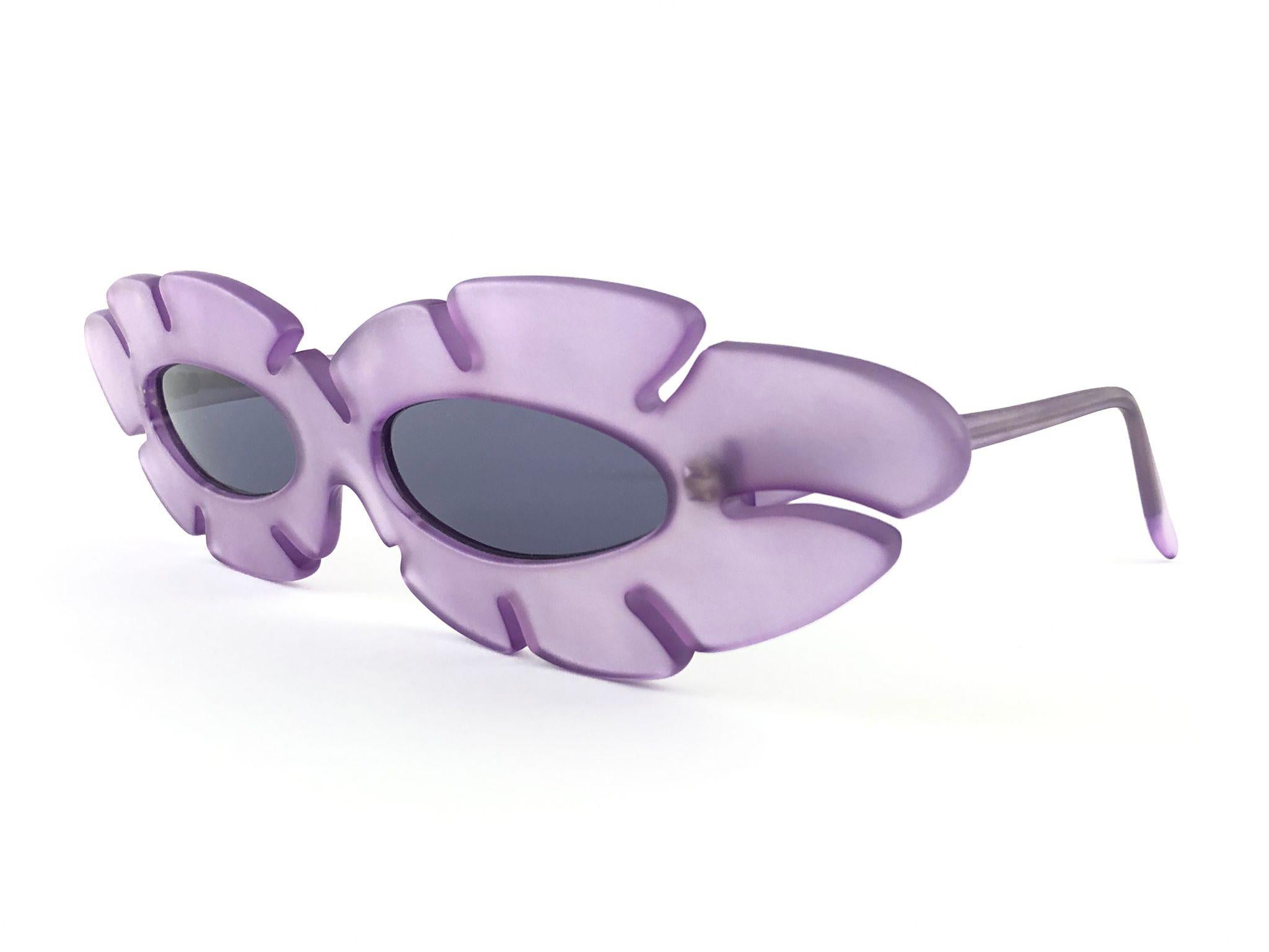 New Vintage Alain Mikli ultra wide translucent light purple frame.

Rare item in new and unworn condition. Spotless grey lenses.

Please consider that this item is nearly 40 years old so it could show minor sign of wear due to storage.

Made in