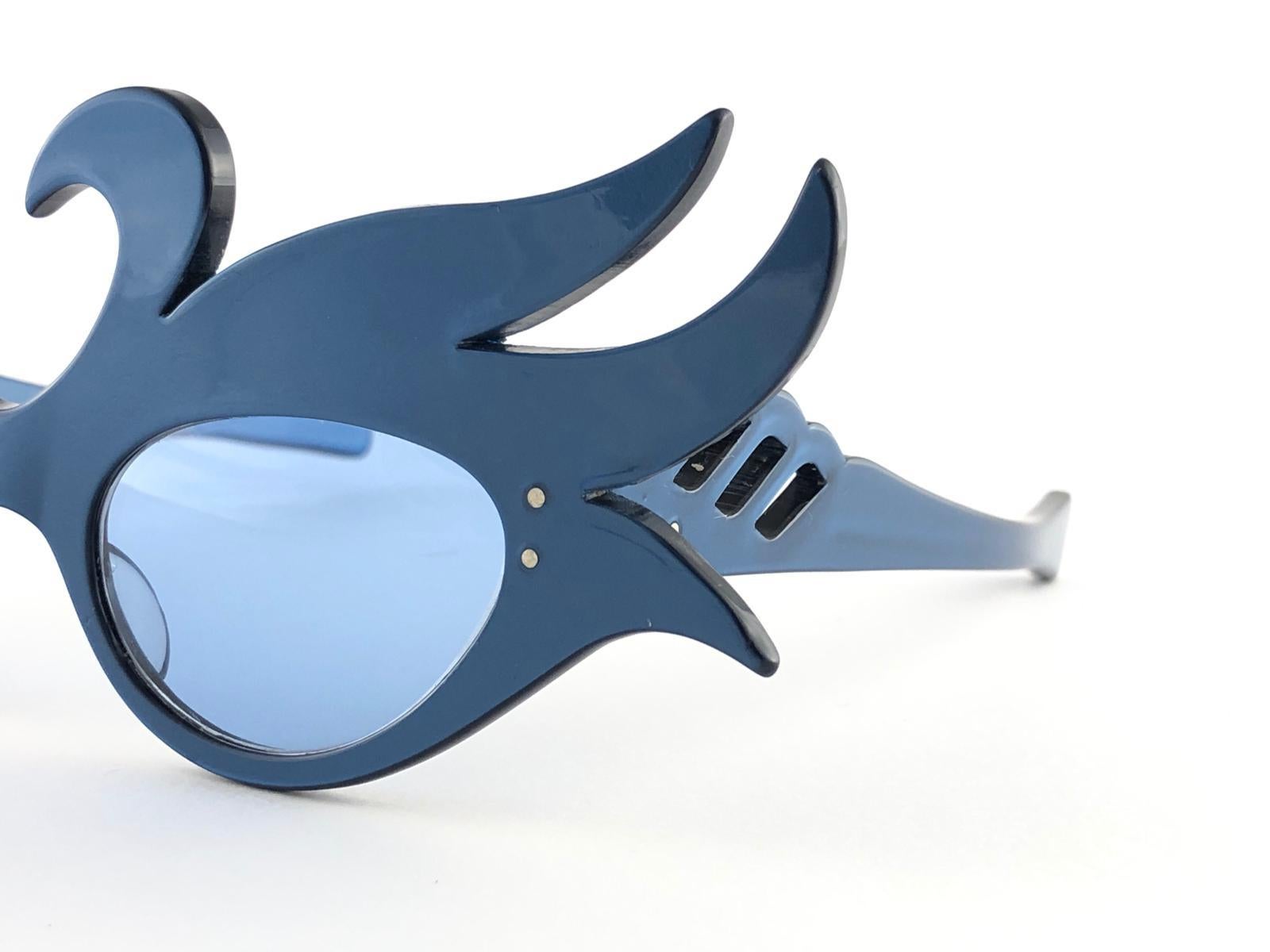New Vintage Alain Mikli blue swans prototype.

Rare item in new and unworn condition. Spotless smoke grey lenses.

Please consider that this item is nearly 40 years old so it could show minor sign of wear due to storage.

Made in