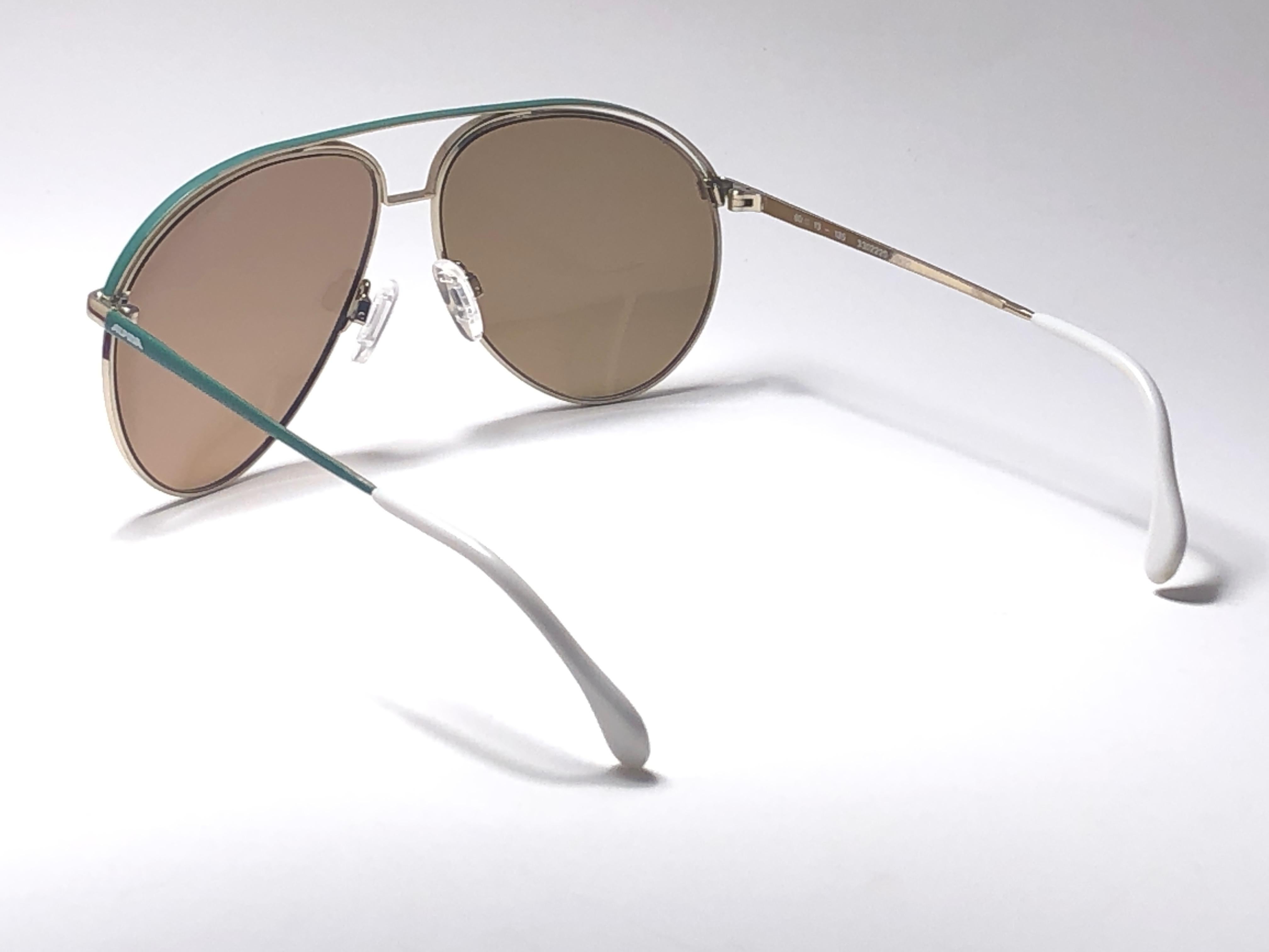 New Vintage Alpina Aviator Sunglasses. Green frame with gold mirror lenses.
This pair has a minor sign of wear due to storage.

Made in West Germany.