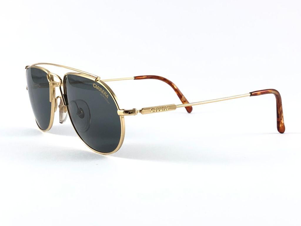 New 1980's Carrera gold sunglasses.

Amazing craftsmanship and quality.   

New, never worn. Made in Austria. This item may show minor sign of wear due to storage.

Measurements 
Measurements


Front  13.5 CMS
Lens Height 4 cms
Lens Width 5.3