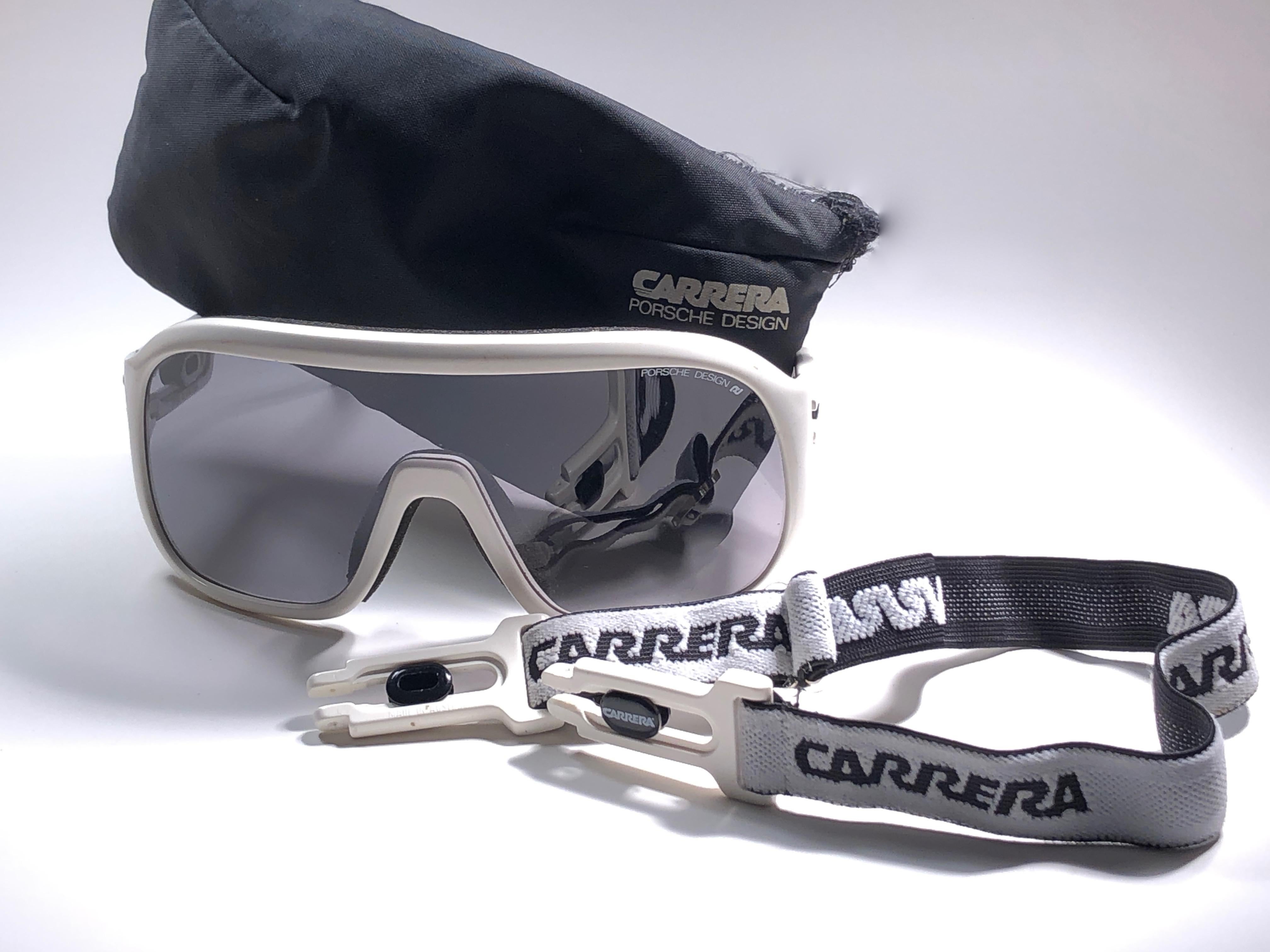 New 1980's Carrera ski oversized frame sporting grey mono lenses lenses.  
Amazing craftsmanship and quality.  

This item has some wear on it due to nearly 40 years of storage. 

Original pouch and elastic sports cord.

New, never worn. Made in
