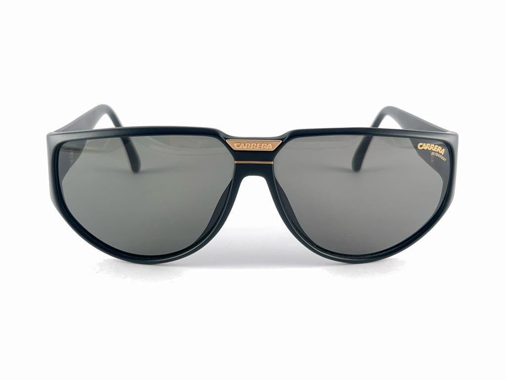 New 1980'S Carrera Collection Matte Black Frame With Medium Grey Lenses.   
Amazing Craftsmanship And Quality.   

New, Never Worn Or Display
This Item May Show Minor Sign Of Wear Due To Storage



Made In Germany



Front                           
