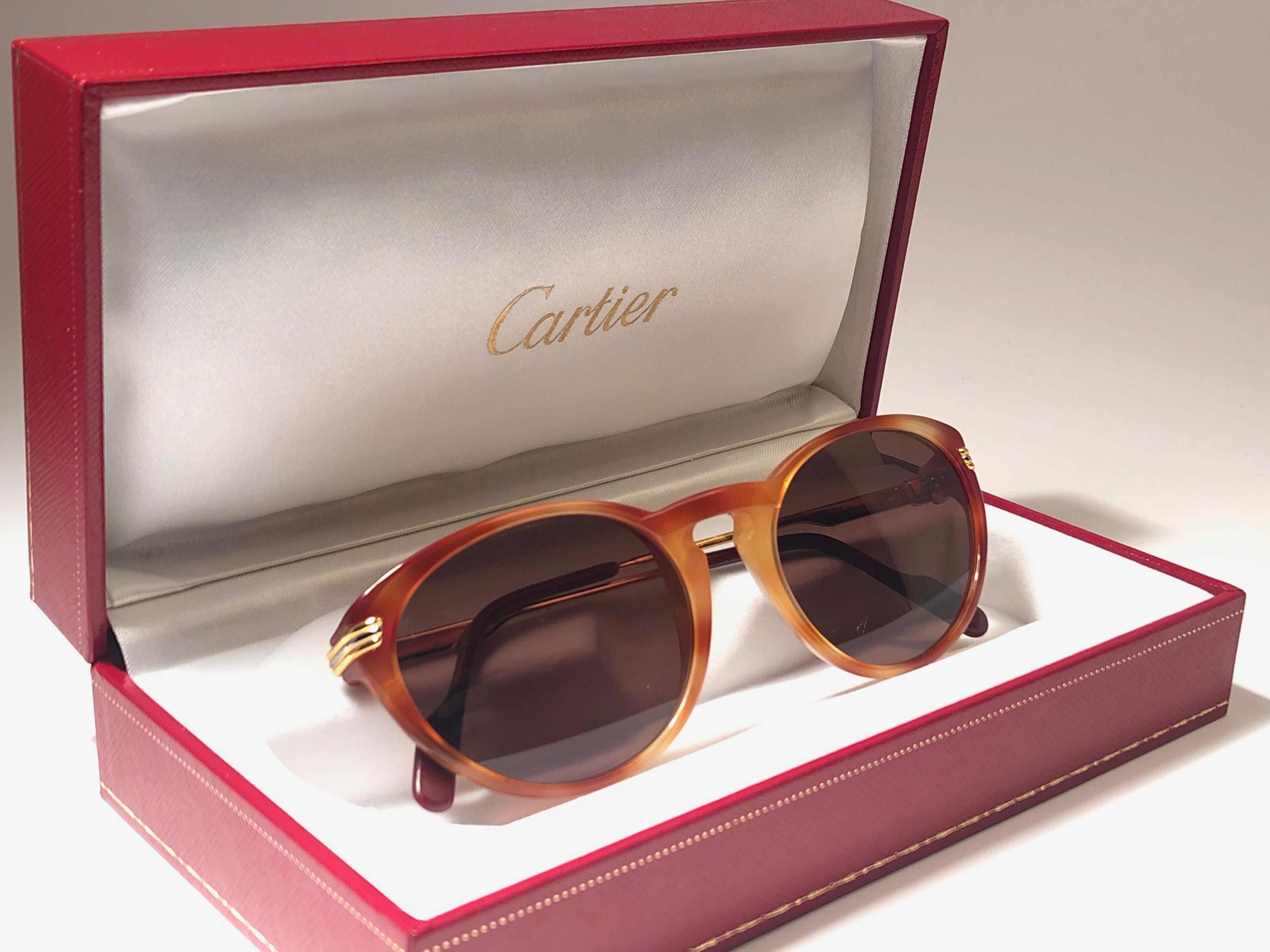 
New Cartier Aurore Classic sunglasses with brown (uv protection) lenses. Small size 50mm/18 frame has the famous real gold and white gold accents on the temples. 100% original. All hallmarks. Cartier gold signs on the earpaddles. These are like a