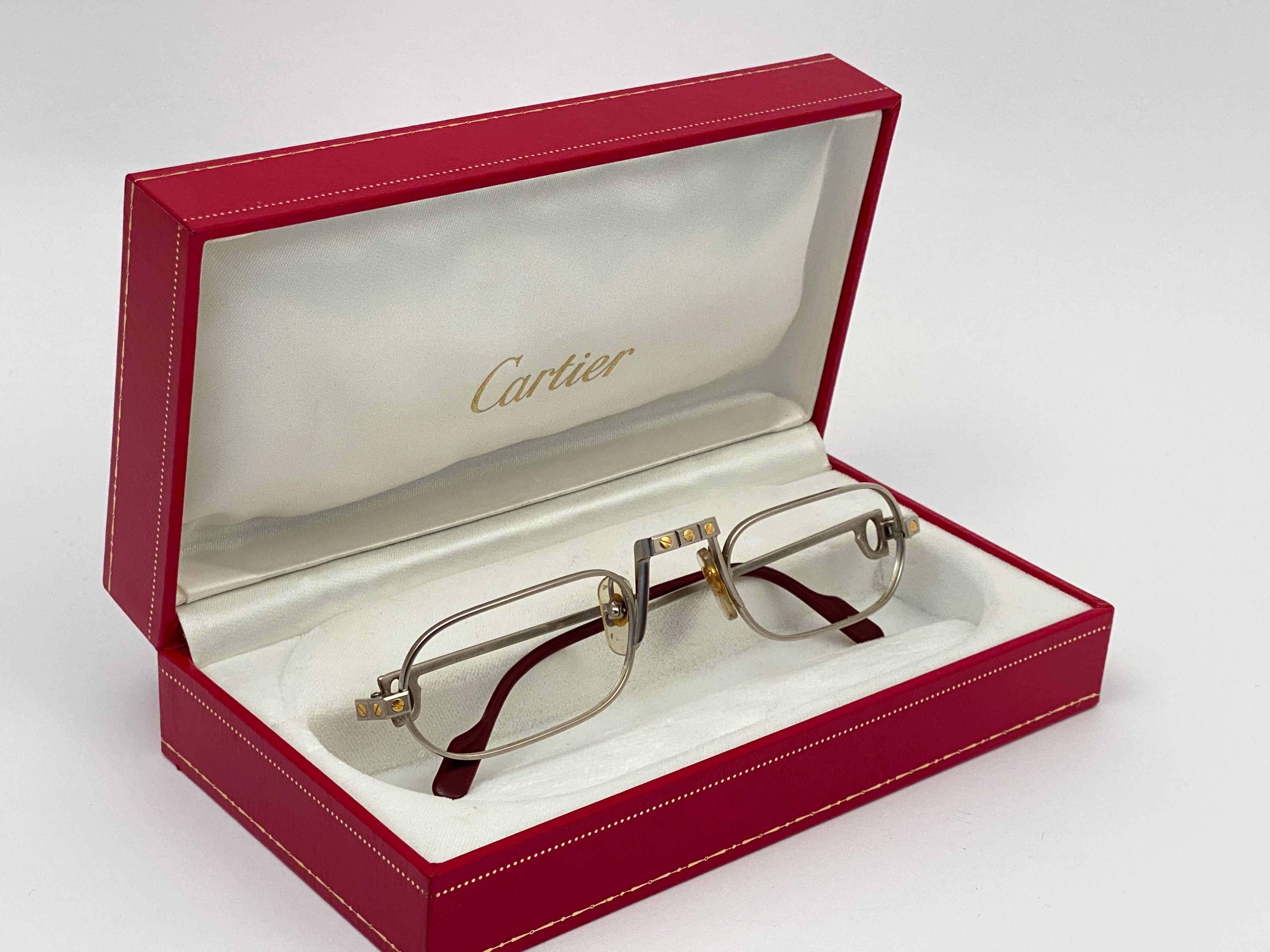 Original 1983 Cartier Demilune Cartier Santos Platine sunglasses ready for RX / prescription lenses. 

Very comfortable as reading glasses. All hallmarks. Red enamel with Cartier gold signs on the burgundy ear paddles. Both arms sport the C from