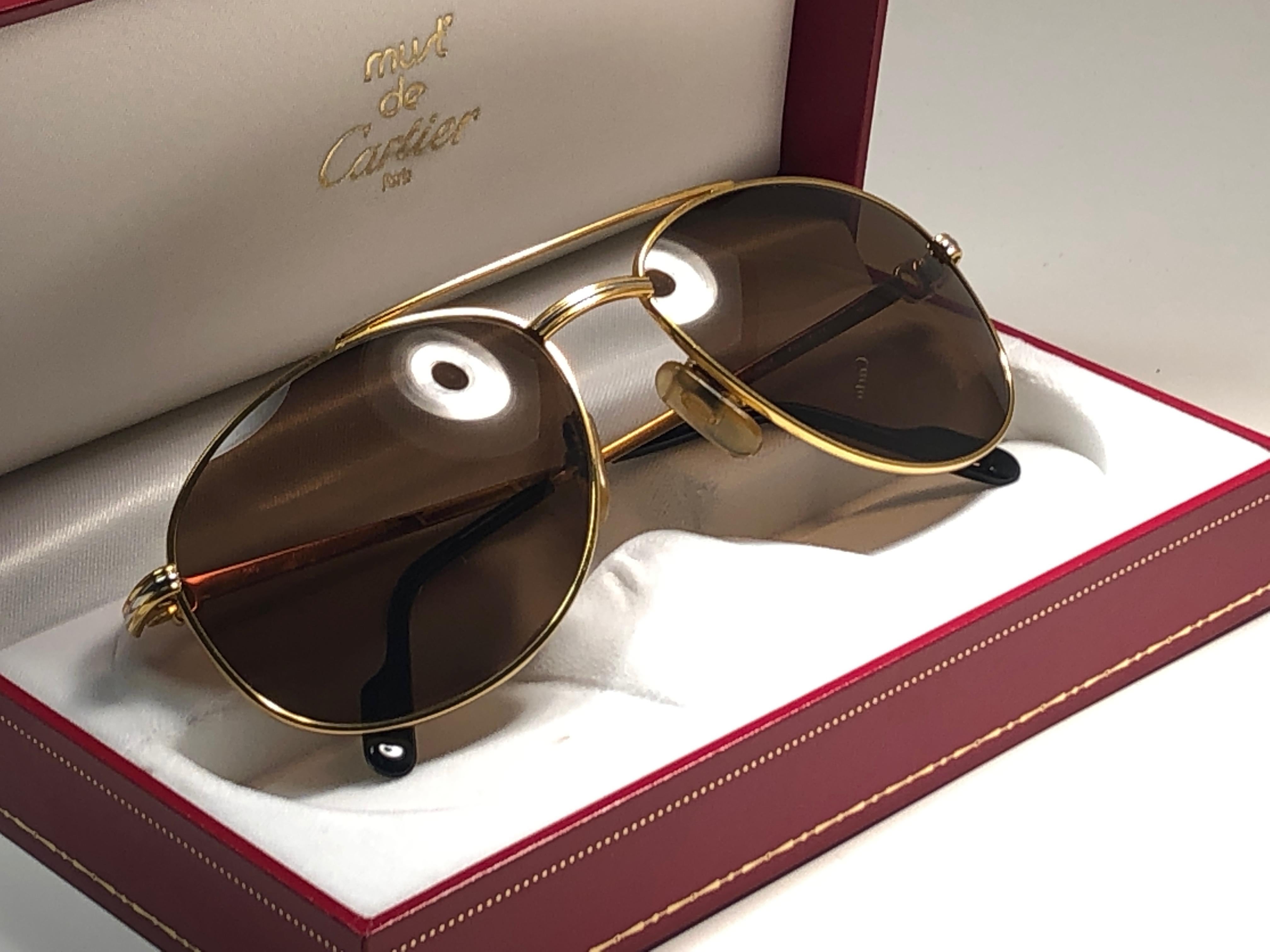 New condition 1990 Cartier Driver 54 [] 18 Sunglasses with brown (uv protection) lenses. All hallmarks. Cartier gold signs on the ear paddles. These are like a pair of jewels on your nose. 
Please notice that this sunglasses are nearly 30 years old