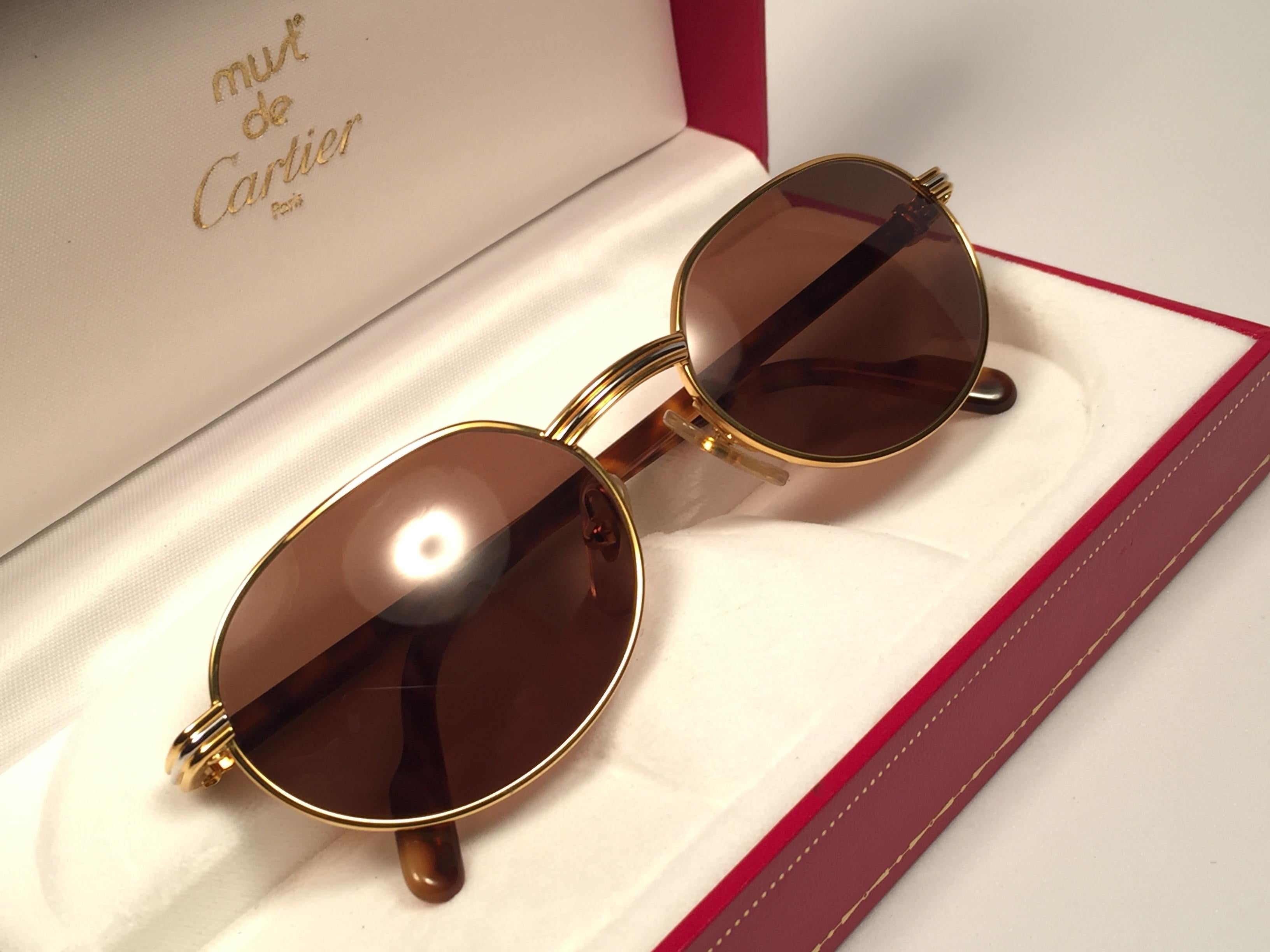 New 1990 Cartier Leur Sunglasses with brown (uv protection) lenses. All hallmarks. Cartier gold signs on the ear paddles. These are like a pair of jewels on your nose. 
Please notice that this sunglasses are nearly 30 years old and could show minor