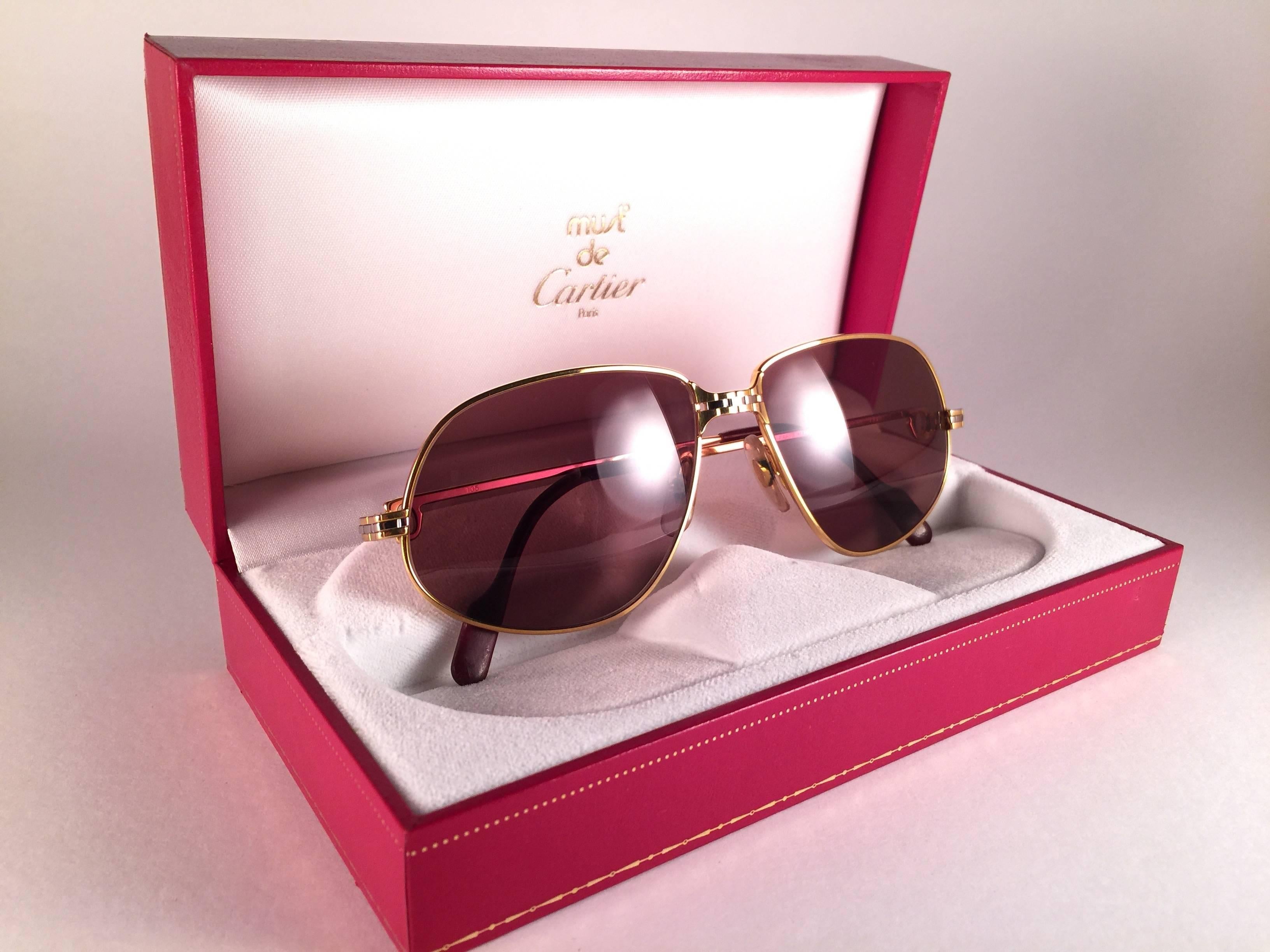 1988 Cartier Panthere sunglasses with brown (uv protection) lenses.  Frame is with the front and sides in yellow and white gold. All hallmarks. burgundy ear paddles. 
Both arms sport the C from Cartier on the temple. 
These are like a pair of jewels